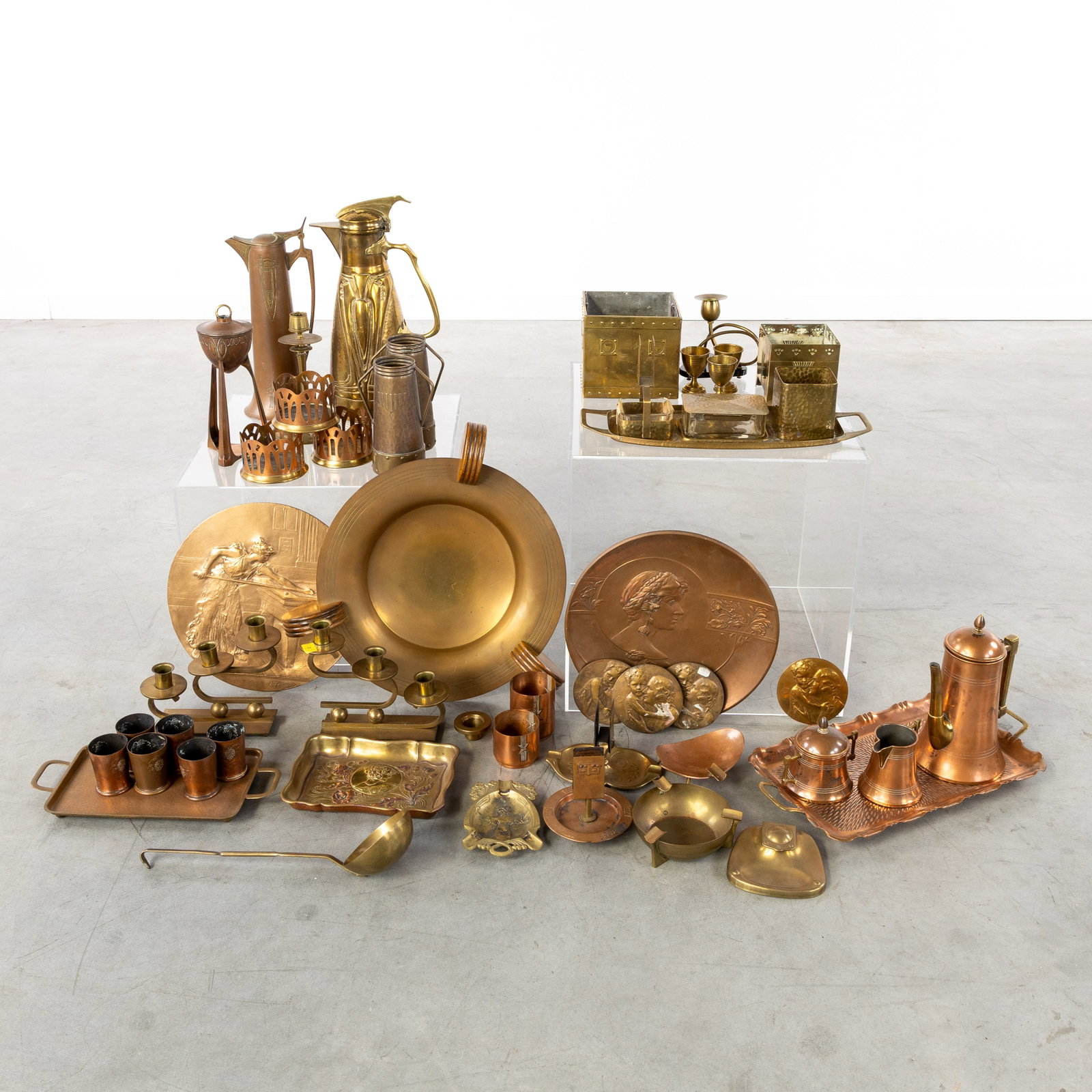 A Collection of Art Nouveau copperware, with pitchers, cache-pots, plaques, and others, 35 pieces,: A Collection of Art Nouveau copperware, with pitchers, cache-pots, plaques, and others, 35 pieces, Art Nouveau, circa 1900-1910. Red and yellow copper. In total circa 35 pieces, with pitchers, ca