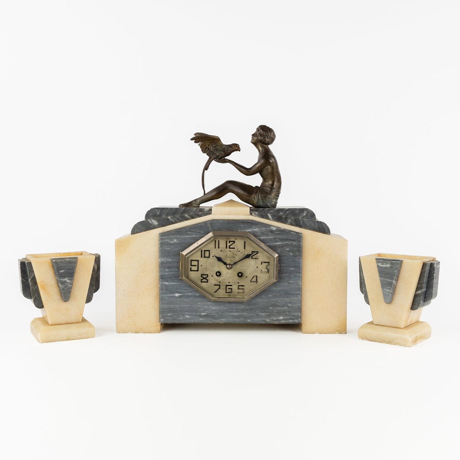 A Three-piece mantel garniture, clock and side pieces, 'Lady with Ara', Spelter, marble, and onyx, (1 of 8)