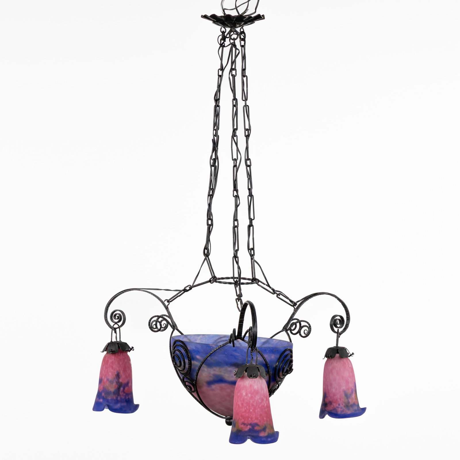 Muller Frères Luneville, a wrought-iron chandelier with a pâte de verre bowl and: Muller Frères Luneville, a wrought-iron chandelier with a pâte de verre bowl and lampshades. Art Deco, circa 1930. Patinated wrought iron and pink/purple pâte de verre.Three pâte d