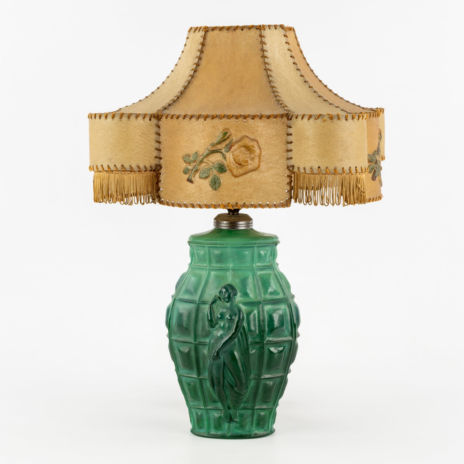 A Malachite glass table lamp, in the style of Hoffmann and Schlevogt, Gablonz, Bohemia, Art Deco,: A Malachite glass table lamp, in the style of Hoffmann and Schlevogt, Gablonz, Bohemia, Art Deco, circa 1930. Malachite glass, finished with a parchment lampshade.Table lamp, decorated with a rectangl