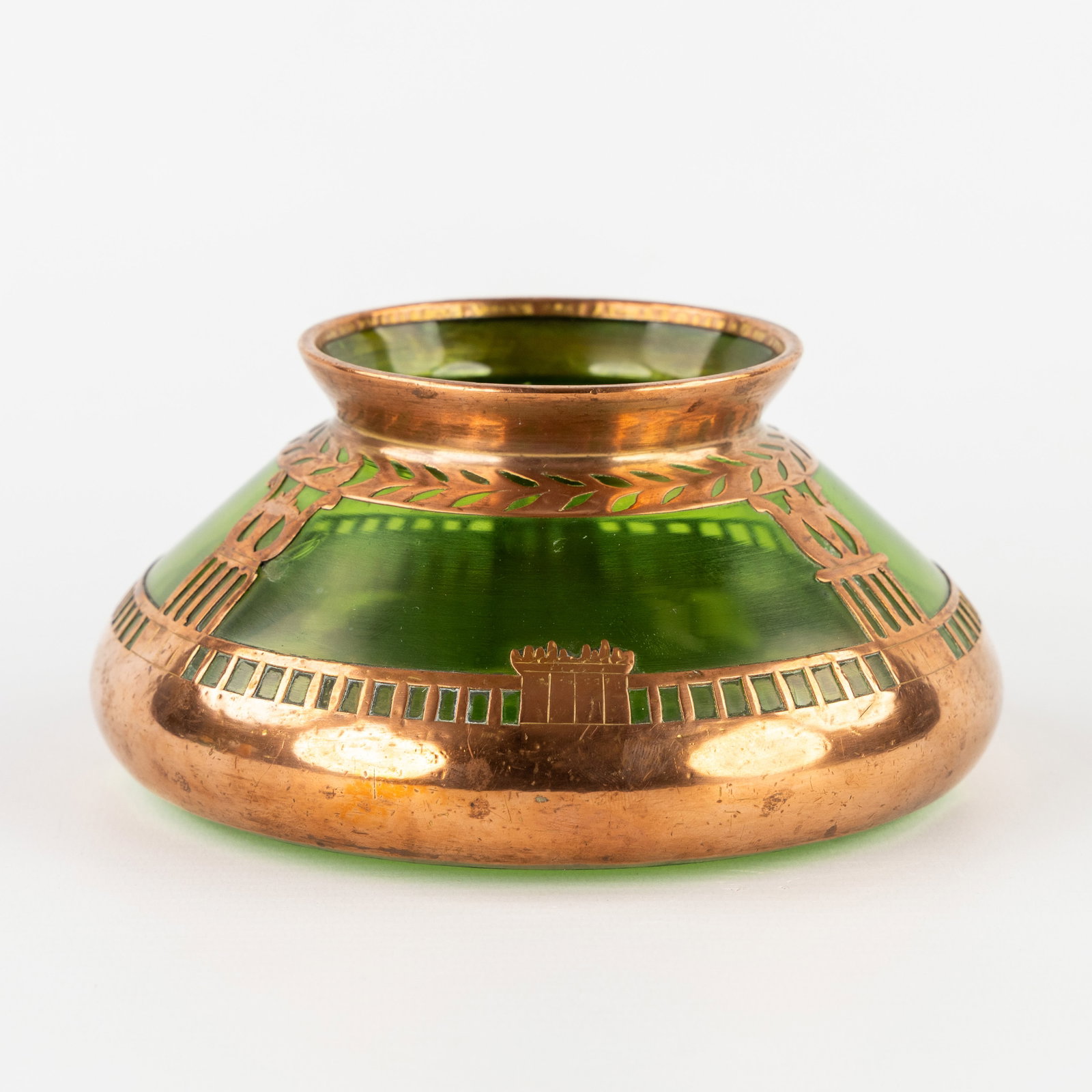 A Small Art Nouveau/Jugendstil vase with a copper mount, in the style of Josef Riedel, Wiener: A Small Art Nouveau/Jugendstil vase with a copper mount, in the style of Josef Riedel, Wiener Secession, circa 1905. Green glass and copper.Round, flattened vase or small bowl with a copper mount.In