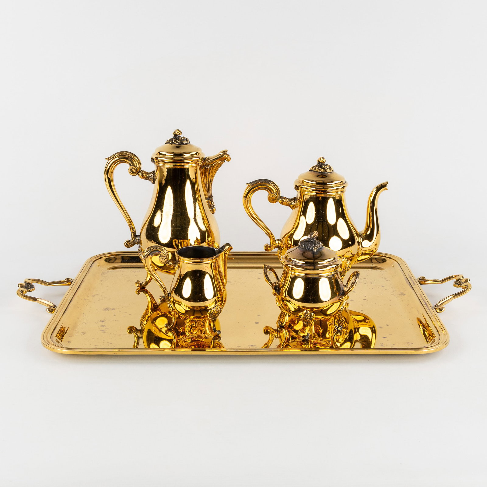 Christofle, Pompadour, a 5-piece coffee and tea service, gold-plated metal.: Christofle, Pompadour, a 5-piece coffee and tea service, gold-plated metal. Coffee potTeapotSugar bowlMilk jugRectangular serving platter Dimensions