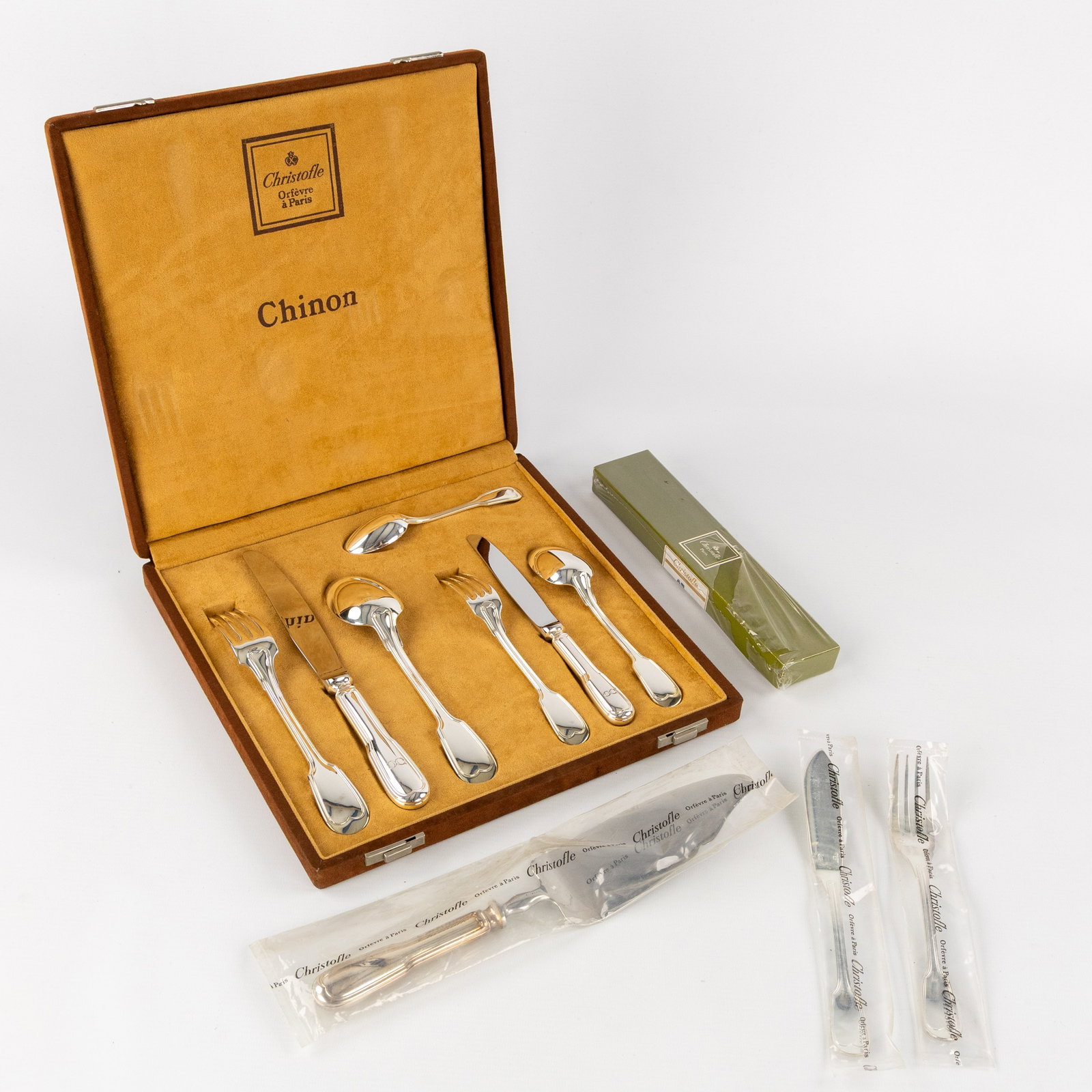 Christofle, Chinon, a 45-piece cutlery set and display case. Silver-plated metal.: Christofle, Chinon, a 45-piece cutlery set and display case. Silver-plated metal. A display box containing one of each item.Large spoonLarge knifeLarge forkSmall spoon