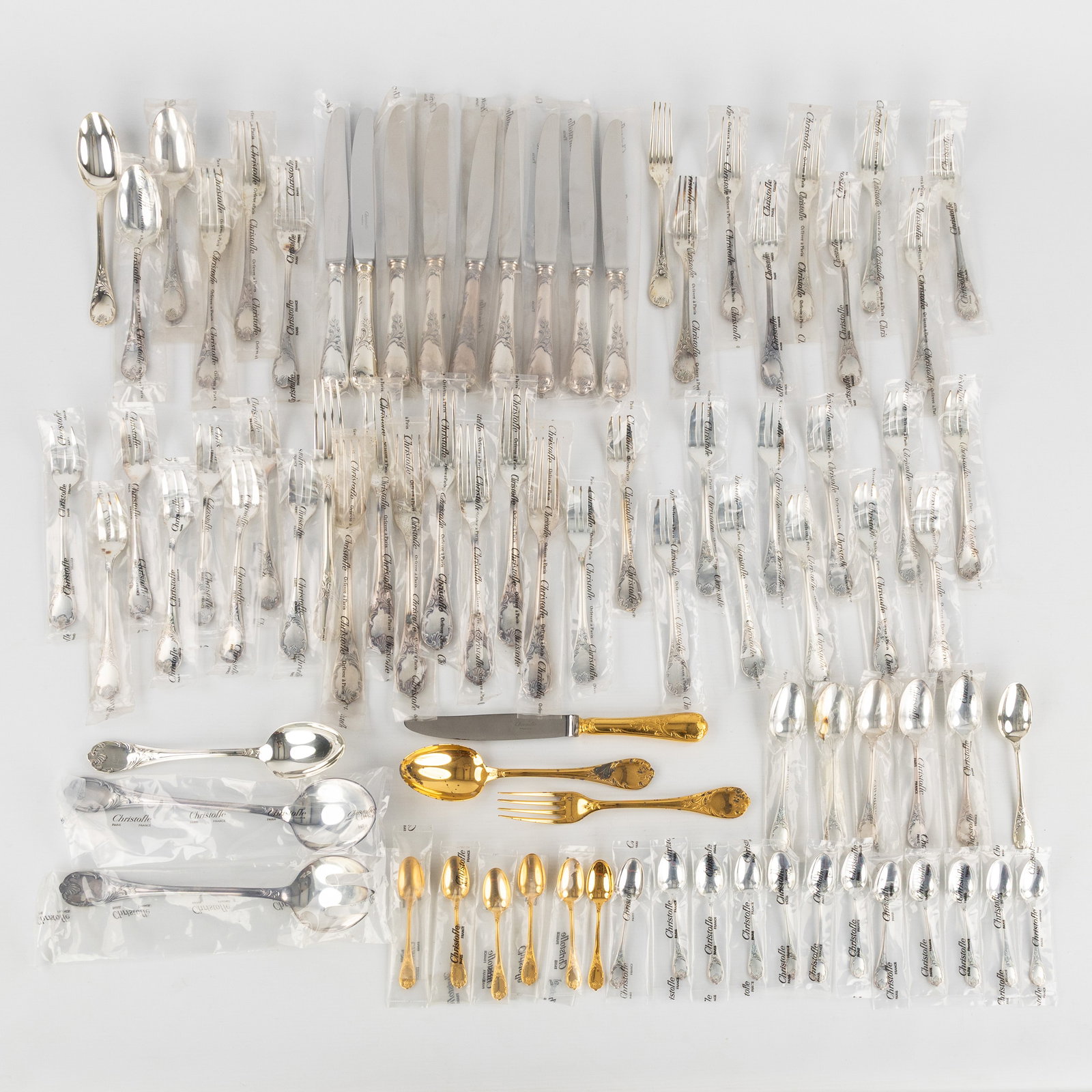 Christofle 'Marly', an 82-piece cutlery set, silver-plated and gold-plated metal. Mostly new in the: Christofle 'Marly', an 82-piece cutlery set, silver-plated and gold-plated metal. Mostly new in the packaging. 9 large forks, 1 of which is gold-plated.10 large knives, 1 of which is gold-plated.2 l