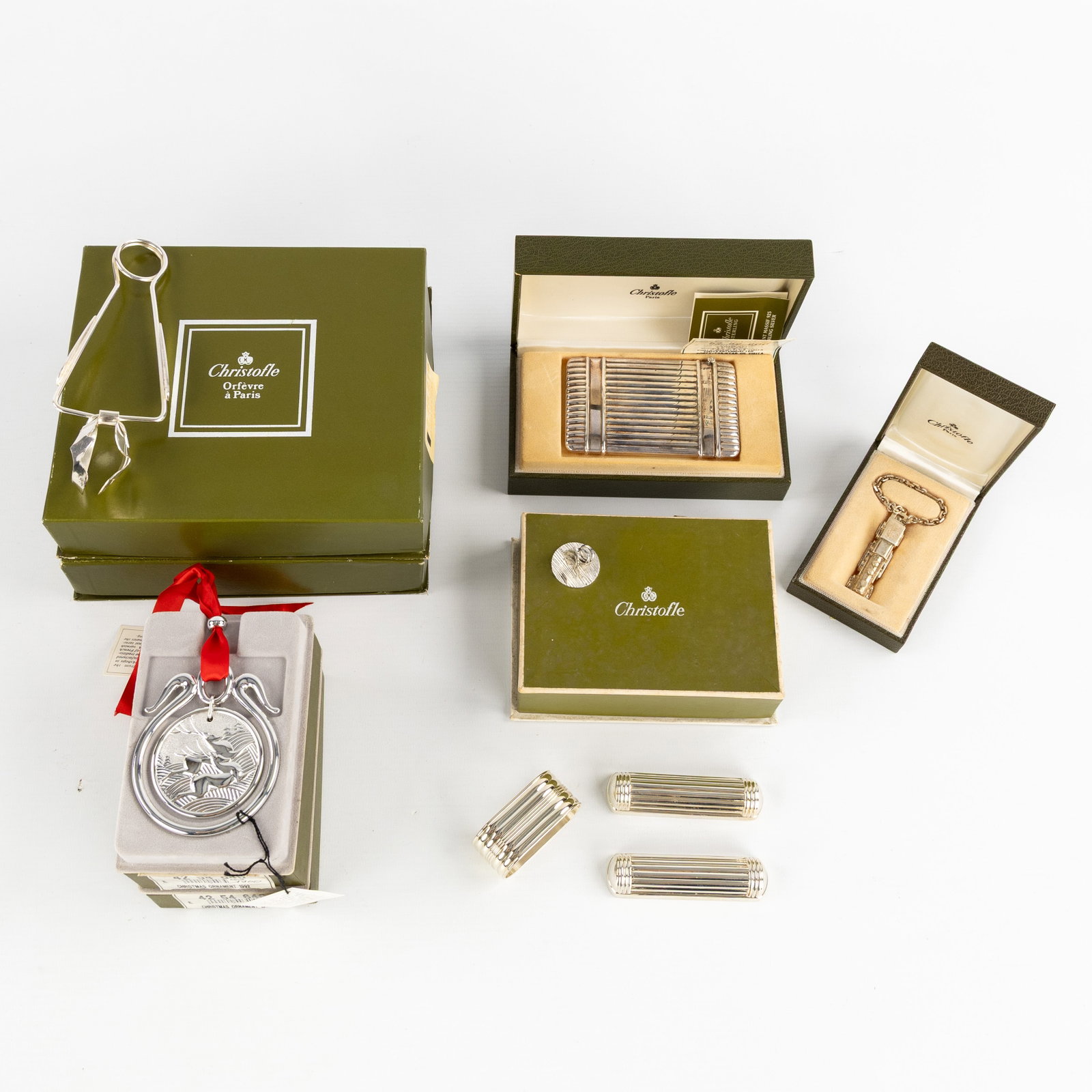 Christofle, a collection of table accessories and tableware. Silver and silver-plated metal.: Christofle, a collection of table accessories and tableware. Silver and silver-plated metal. 12 snail tongs, silver-plated metal.Turban – a business card holder, silver. 925/1000.Train, a key