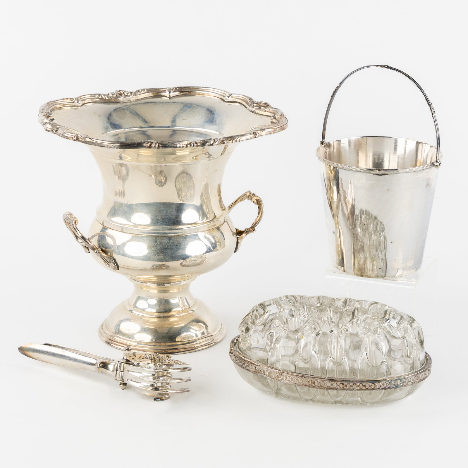 A Champagne bucket, ice pail, pique-fleurs, and lemon press, silver-plated metal. (1 of 3)