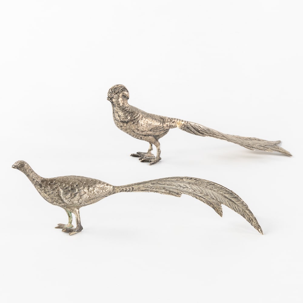 A Pair of Small Silver Pheasants. Silver, 206g.: A Pair of Small Silver Pheasants. Silver. A pair of silver pheasants with openwork tail feathers, rooster and hen.Grade marked 800, for 800/1000.Maker's mark: UMC in an eared covered vase.