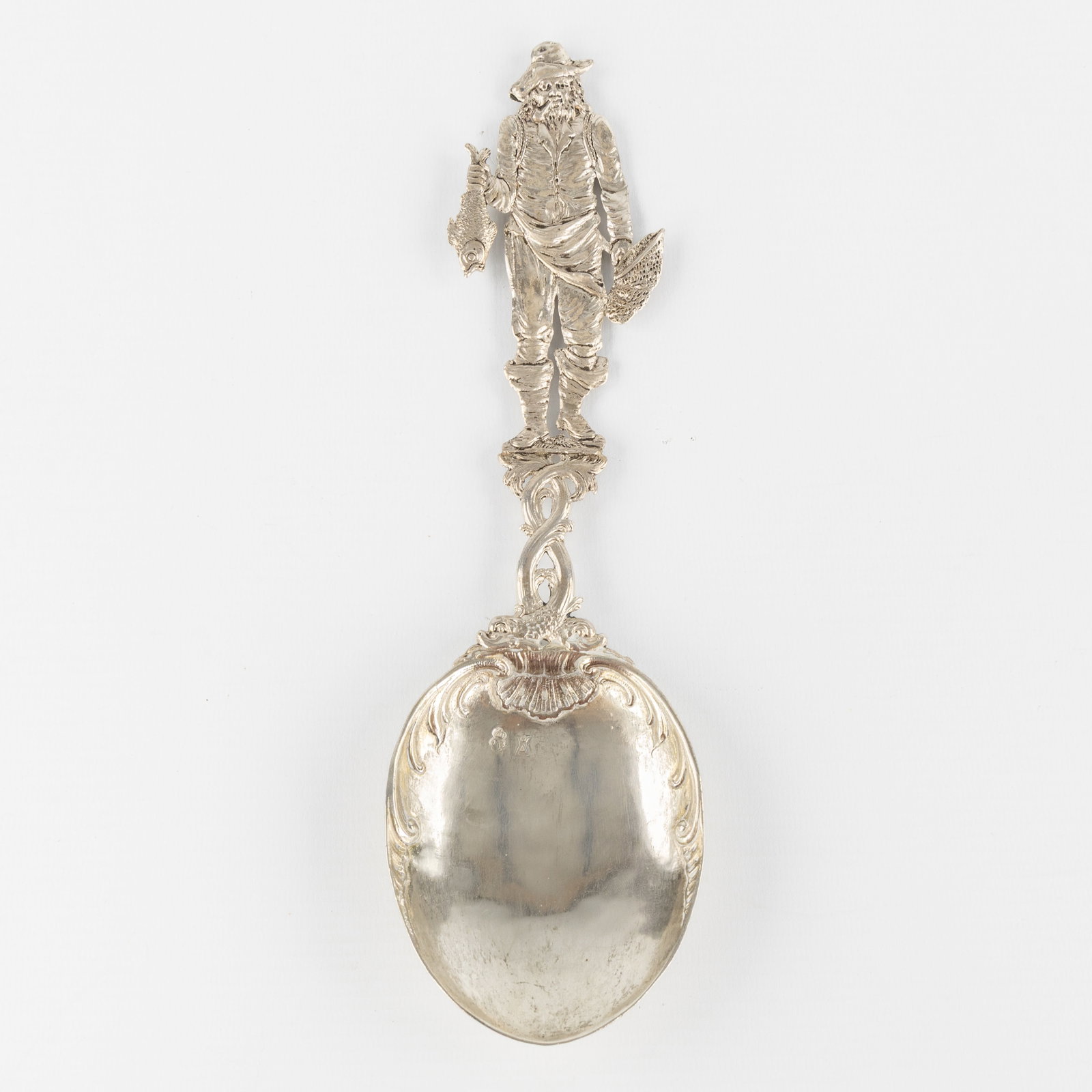 Georg Roth & Cie, a silver ornamental spoon in 18th-century Dutch style, Hanau, Germany, circa 1900.: Georg Roth & Cie, a silver ornamental spoon in 18th-century Dutch style, Hanau, Germany, circa 1900. Silver. Silver. Ornamental spoon, decorated with a sculpture of a fisherman with a fish and fishing
