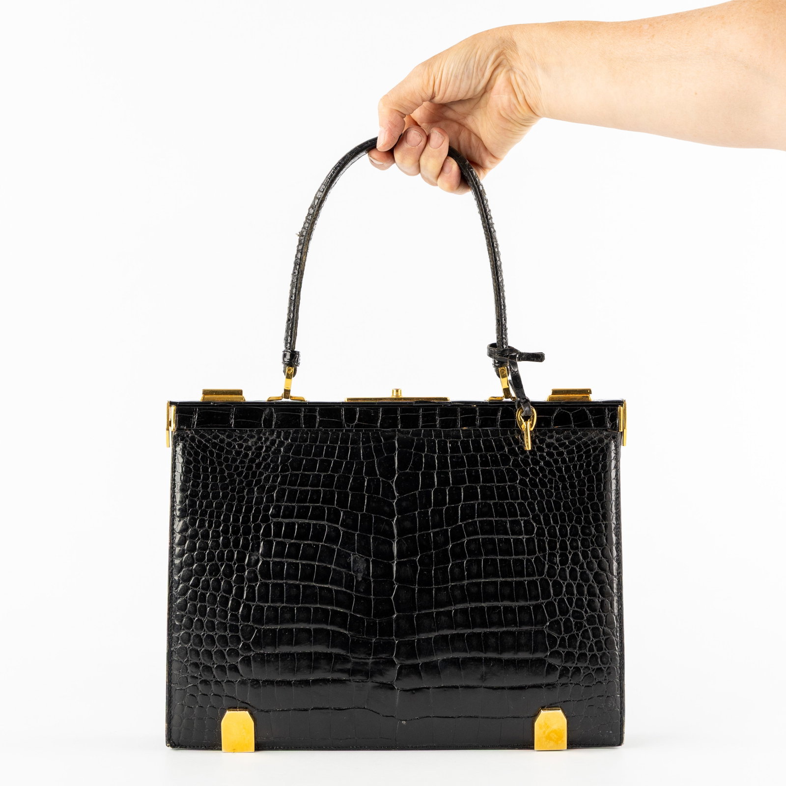 Delvaux ‘Mon Grand Bonheur’, a handbag. Alligator leather and gold-plated hardware.: Delvaux ‘Mon Grand Bonheur’, a handbag. Alligator leather and gold-plated hardware. Circa 1960. Designed by Delvaux in 1959 for the wedding of Queen Paola to King Albert II of Belgium.Alli