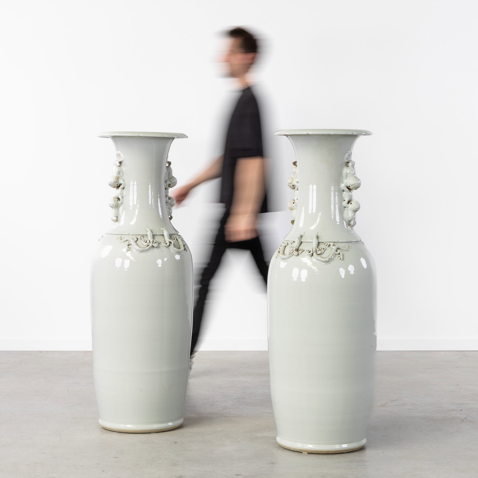 A Pair of large Chinese vases (H: 121 cm), Blanc de Chine, decorated with Dragons and Foo dogs, 20th: A Pair of large Chinese palace vases (H: 121 cm), Blanc de Chine, decorated with Dragons and Foo dogs, 20th century. Chinese porcelain, Blanc de Chine.A pair of large baluster vases.Decorated with s
