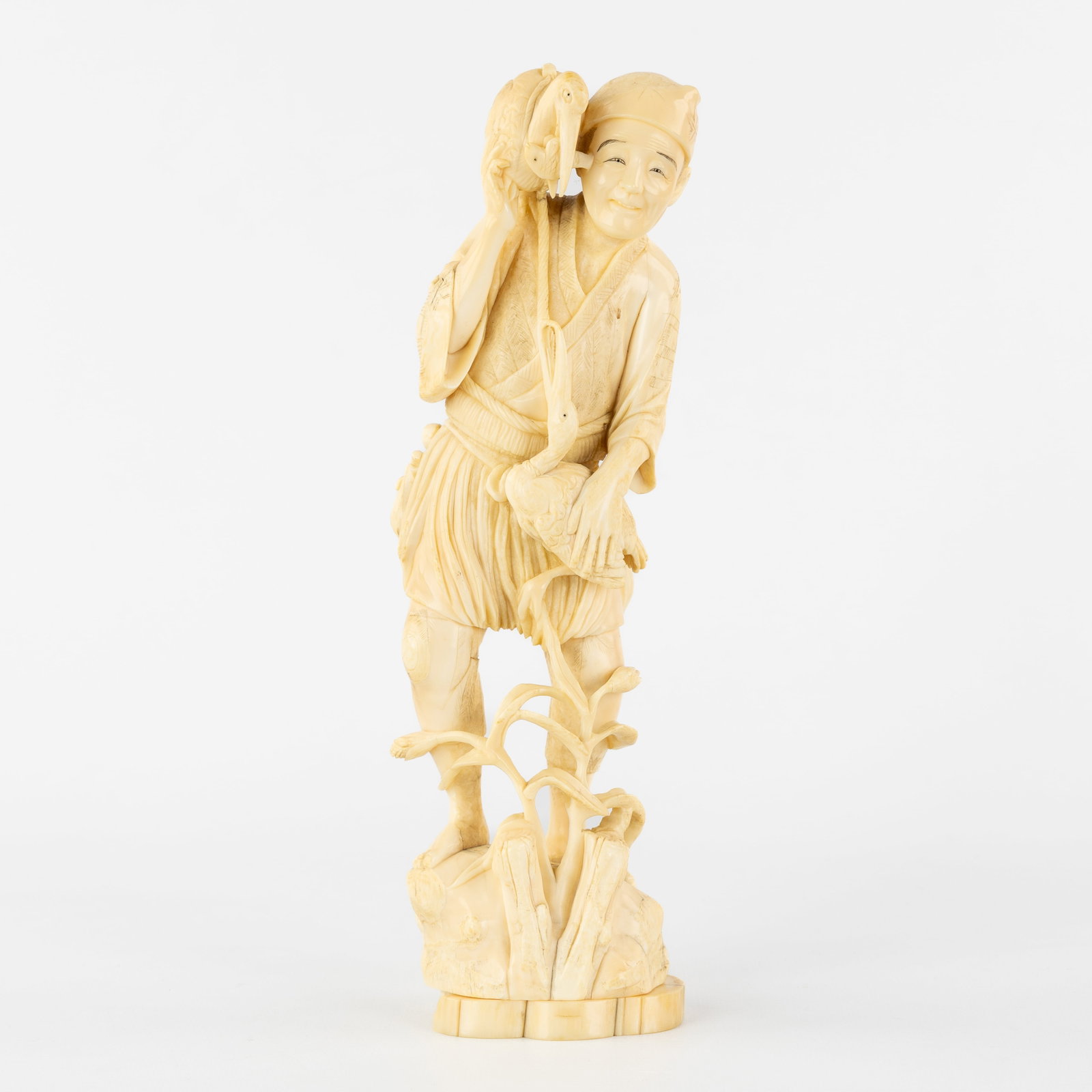 A Japanese Okimono of an Ukai or Bird Fisherman, Meiji, 19th C.: A Japanese Okimono of an Ukai or Bird Fisherman, Meiji, 19th century. Sculptured ivory.Depicting an Ukai or fisherman with cormorants.Gross weight: 829g.Japan, Meiji, 19th century.<