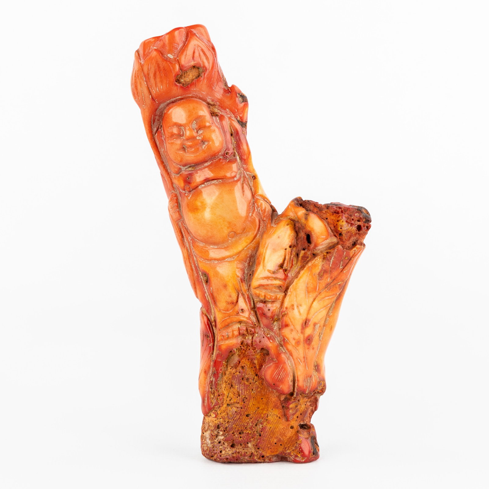 A Chinese coral sculpture with a 'Laughing Buddha or Hotei', 19th/20th C.: A Chinese coral sculpture with a 'Laughing Buddha or Hotei', 19th/20th century. Sculptured red coral.Coral with bas-relief sculpture of a laughing Buddha or Hotei. Total gross weight: