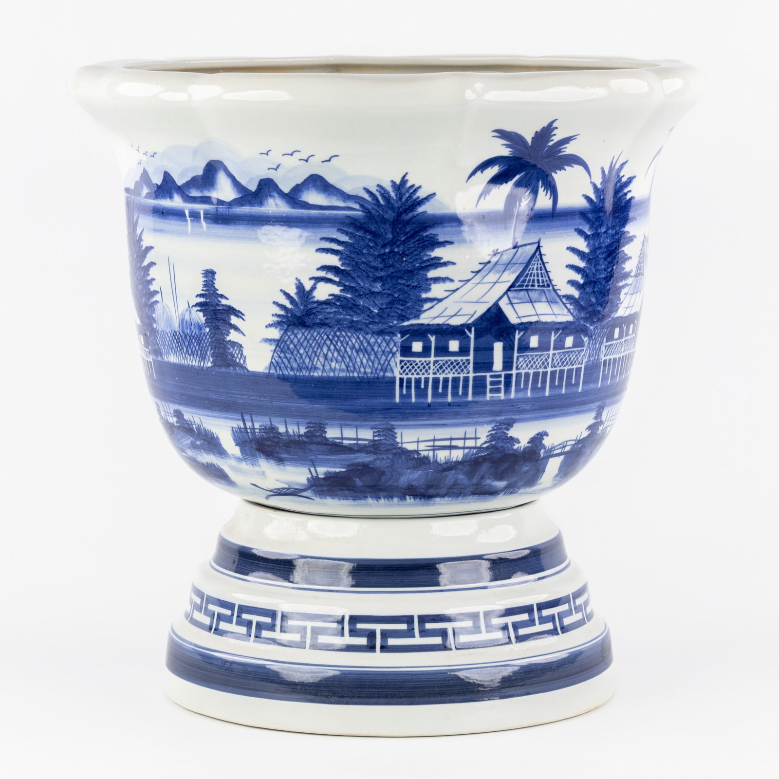 A Chinese blue and white jardinière on a base, 20th C.: A Chinese blue and white jardinière on a base, 20th century. Chinese porcelain, blue and white.Landscape decoration.Base or plinth finished with a meandering border. Tw