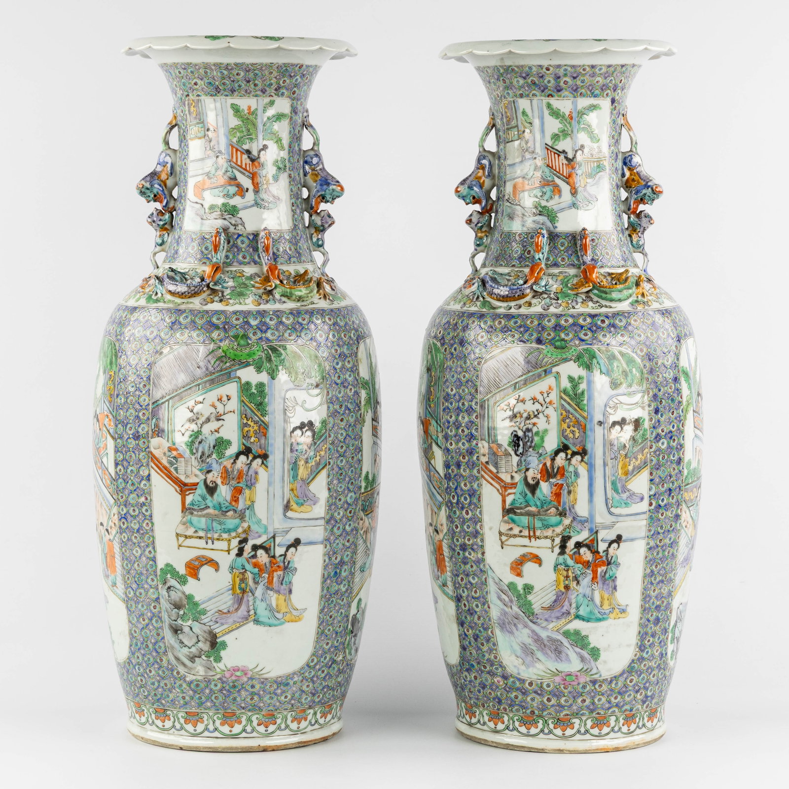 A Pair of Chinese vases, Famille Verte, decorated with palace scenes, Foo Dogs, and dragons, 19th C.: A Pair of Chinese vases, 