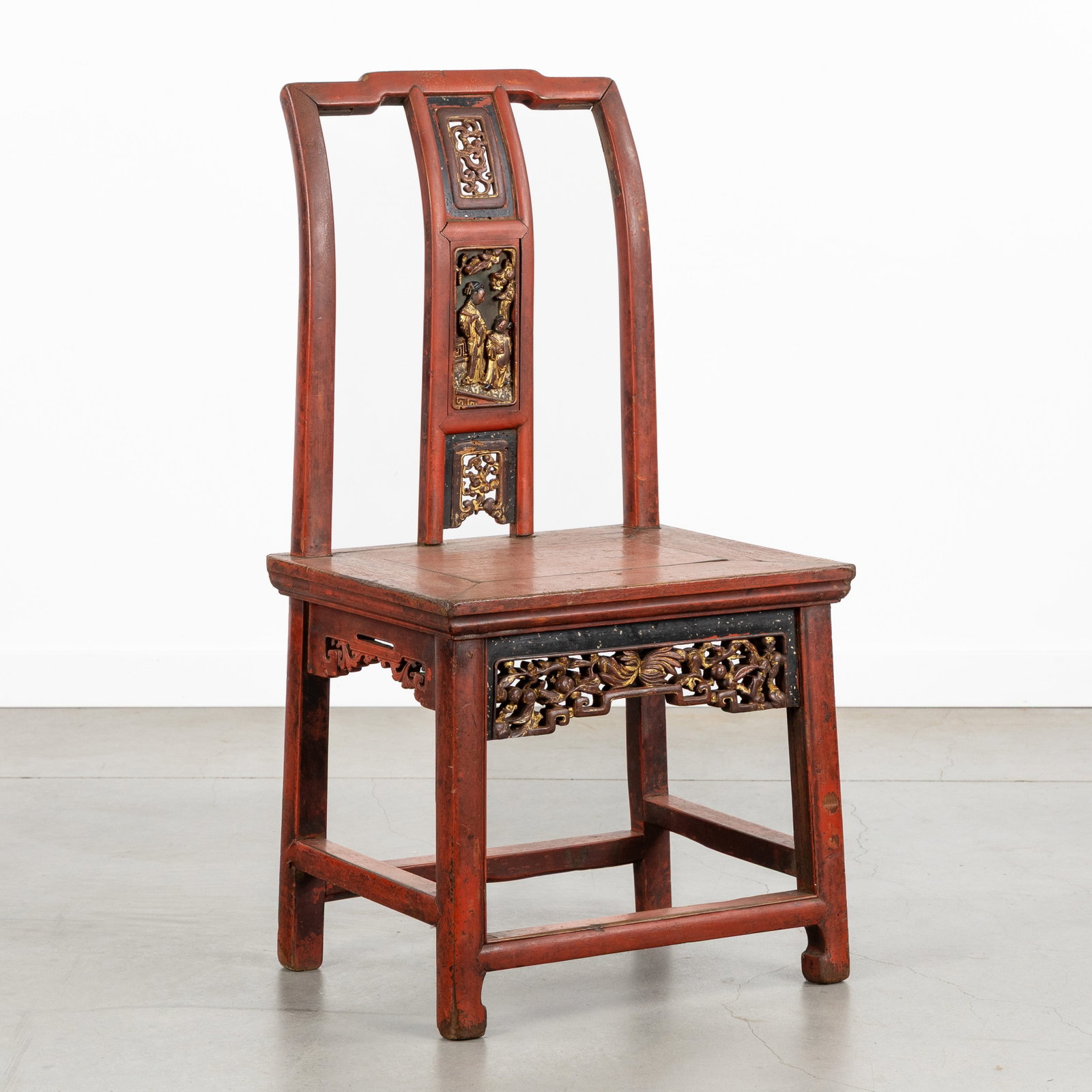 An Antique Chinese red-lacquered and gilded children's chair, circa 1900.: An Antique Chinese red-lacquered and gilded children's chair, circa 1900. Sculptured, red-lacquered and gilded wood.Children's chair or small chair, with openwork sculptured Lingzhi, floral decoration