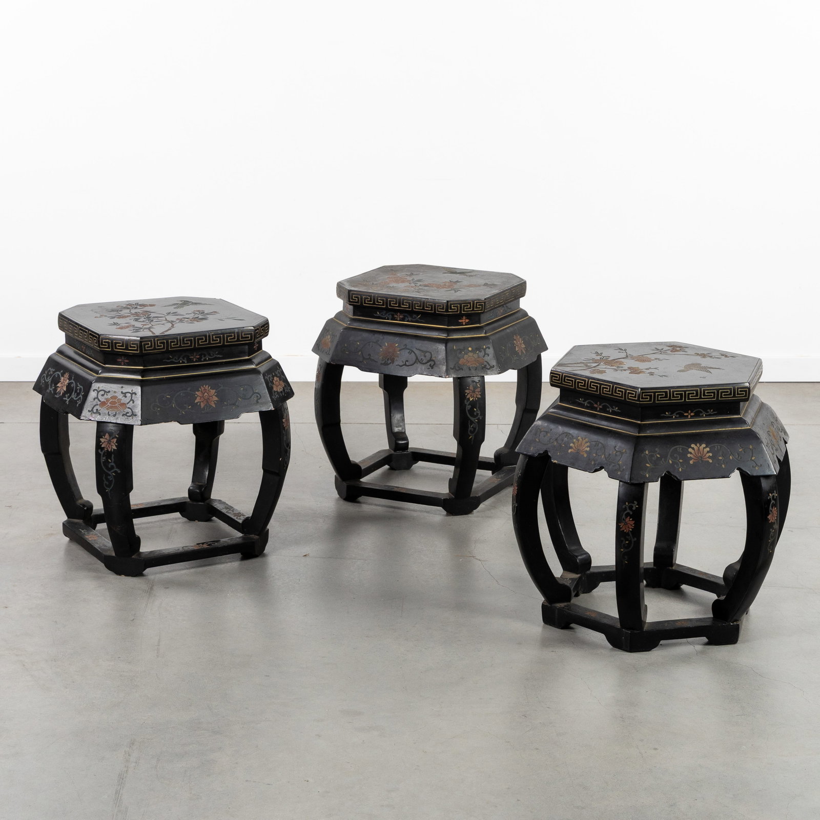 Three Oriental black lacquered stands or pedestals, floral decor with birds, 20th C.: Three Oriental black lacquered stands or pedestals, floral decor with birds, 20th century. Sculptured and black lacquered wood.A pair of octagonal stands and a hexagonal stand.Decorated with peonies