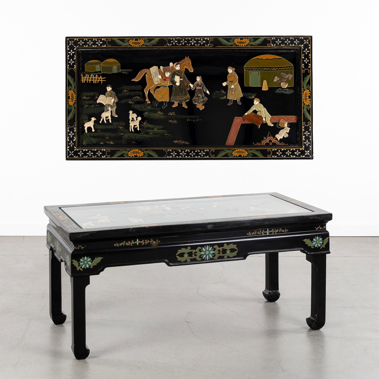 A Chinese black lacquered low table or coffee table with figurative relief decoration, sculptured: A Chinese black lacquered low table or coffee table with figurative relief decoration, sculptured wood and natural stone, 20th century. Sculptured and patinated/lacquered wood. Tabletop with figurativ