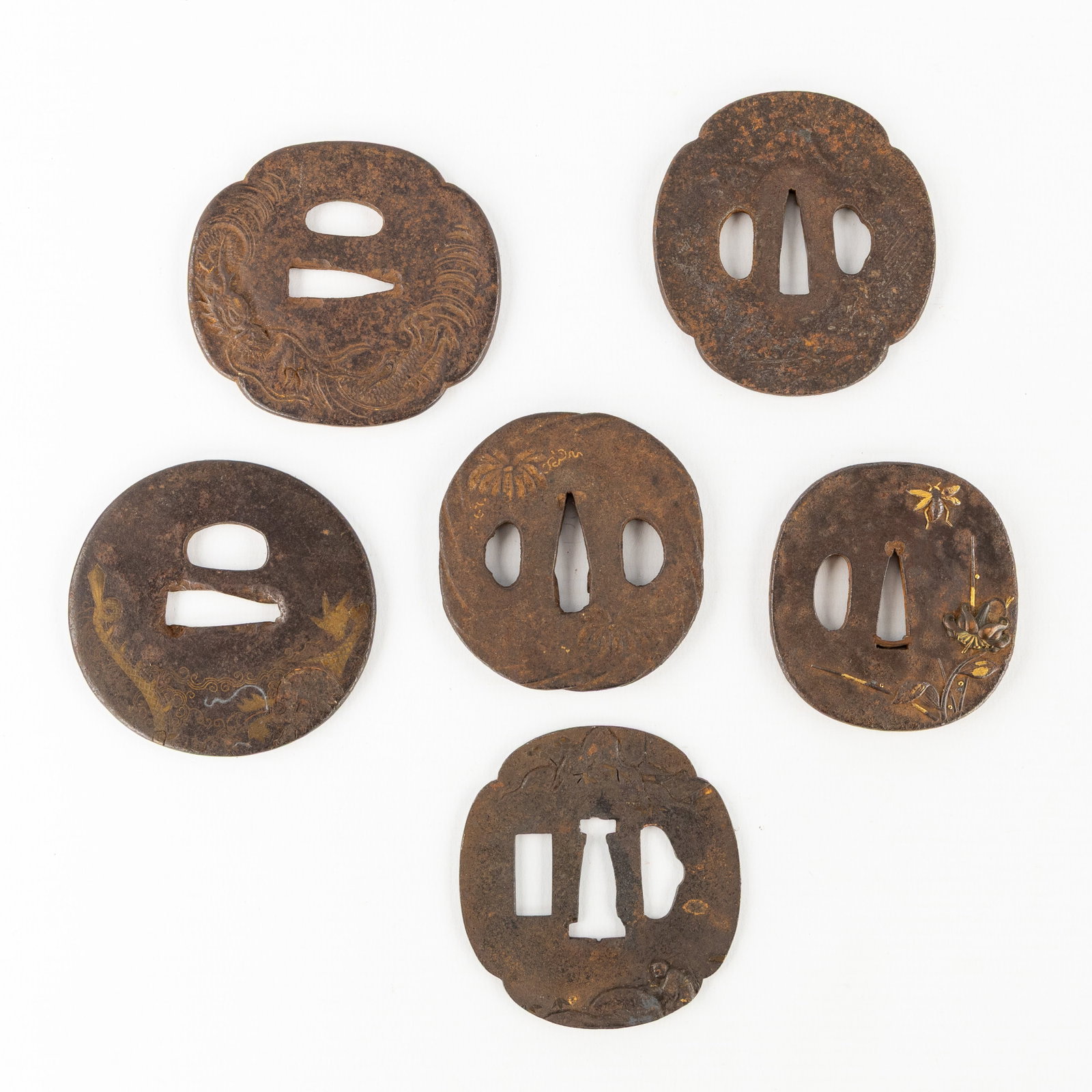 Six Japanese Tsuba, wrought iron, decorated with dragons, landscapes, and flowers, Edo-Meiji period,: Six Japanese Tsuba, wrought iron, decorated with dragons, landscapes, and flowers, Edo-Meiji period, 18th/19th century. Wrought iron, with traces of gilded finish.Tsuba or guard/handguard of a Japanes