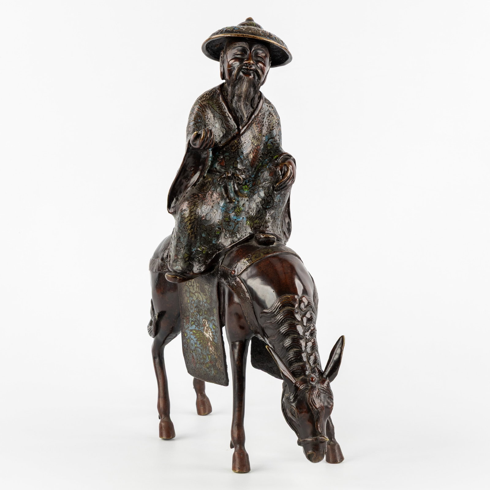 A Chinese Champlevé bronze sculpture of Su Shi on a Mule, marked Xuande, circa 1900.: A Chinese Champlevé bronze sculpture of Su Shi on a mule, marked Xuande, circa 1900. Bronze and Champlevé enamel.Sculpture depicting Su Shi (or Toba), an important official during the Song D
