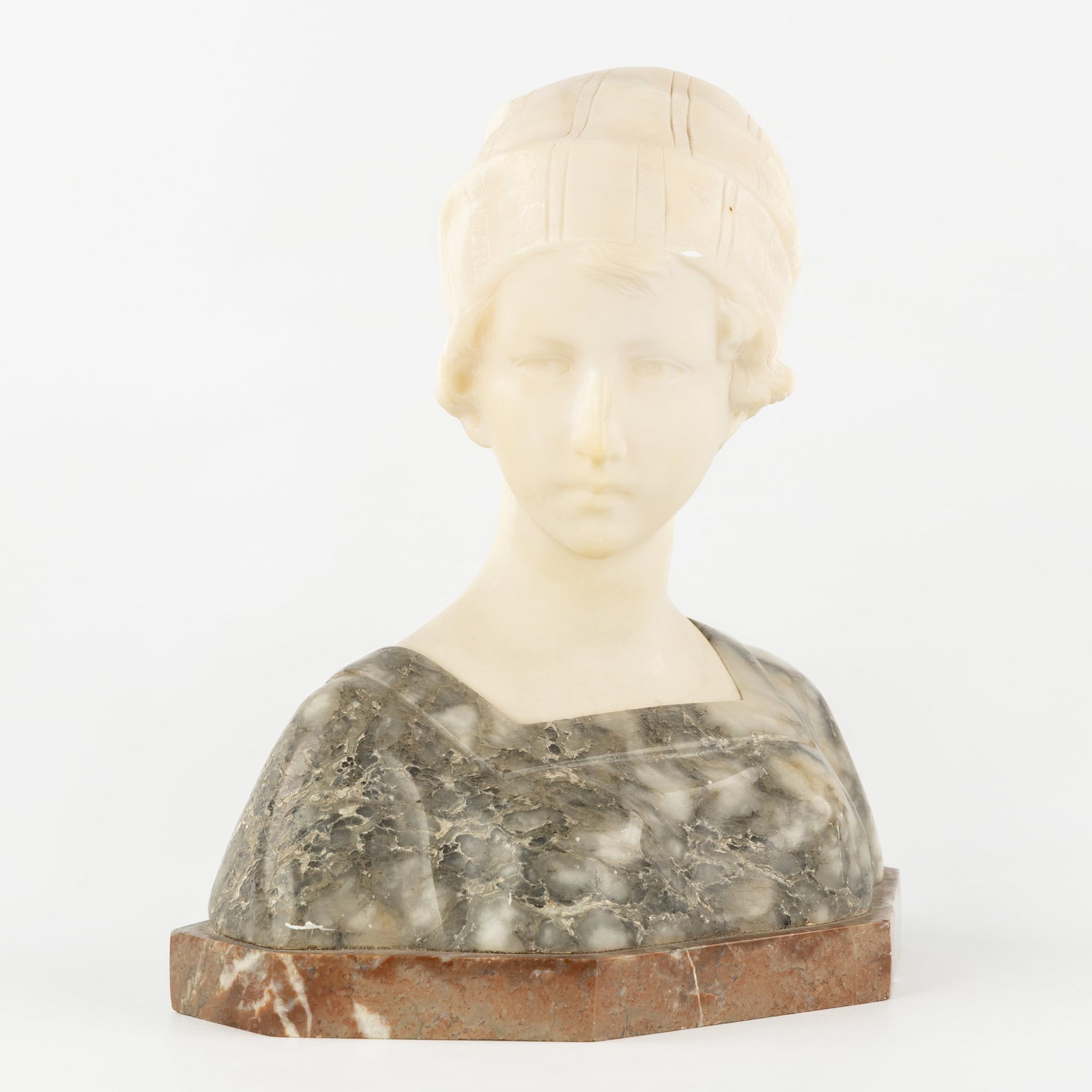 Richard Aurili (1864-1943) 'Bust of a Young Lady', multicoloured alabaster.: Richard Aurili (1864-1943) 'Bust of a Young Lady', multicoloured alabaster. Sculptured multicoloured and white alabaster.Mounted on a marble base.Signed 'R. Aurili'. (22 x 24 x 12 cm)