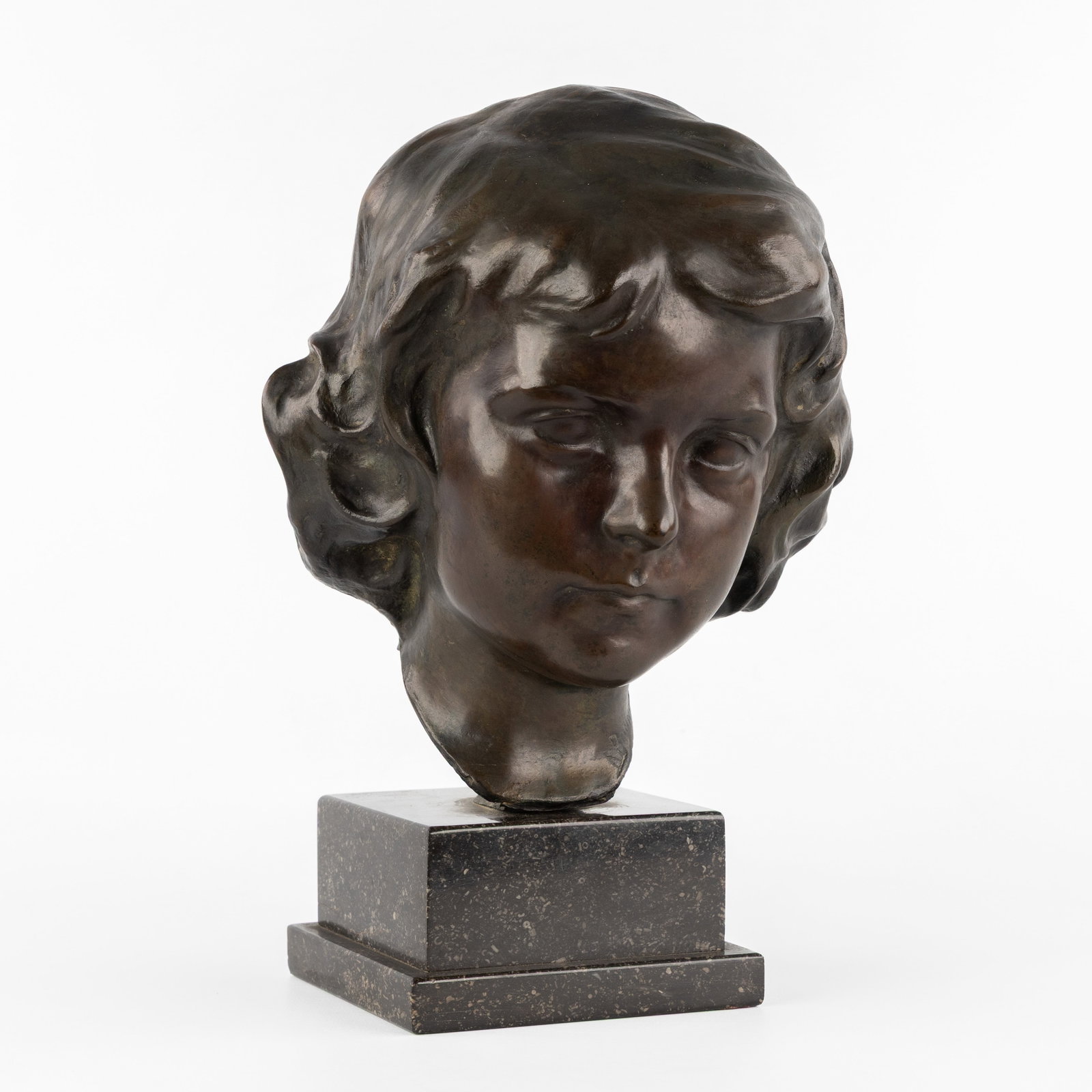 Karel Bonaugure (1880–1947) 'Head of a Girl', patinated bronze, circa 1900.: Karel Bonaugure (1880–1947) 'Head of a Girl', patinated bronze, circa 1900. Patinated bronze, mounted on a bluestone base.Signed 'K Bonaugure'. Total height, including the base: