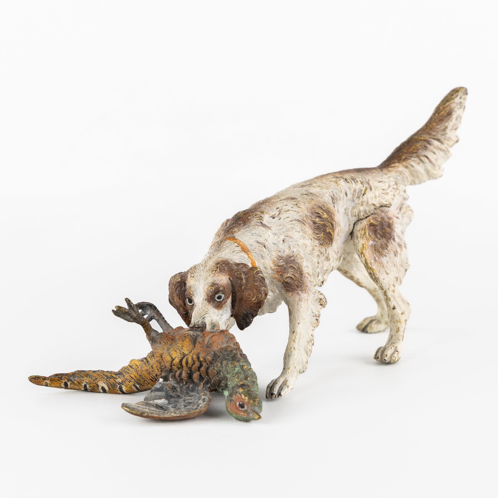 A Hunting dog with a pheasant, Viennese bronze, in the style of Franz Bergmann, Austria, circa 1900.: A Hunting dog with a pheasant, Viennese bronze, in the style of Franz Bergmann, Austria, circa 1900. Polychrome cold-patinated bronze.Depiction of a hunting dog with a shot pheasant in its mouth. Prob