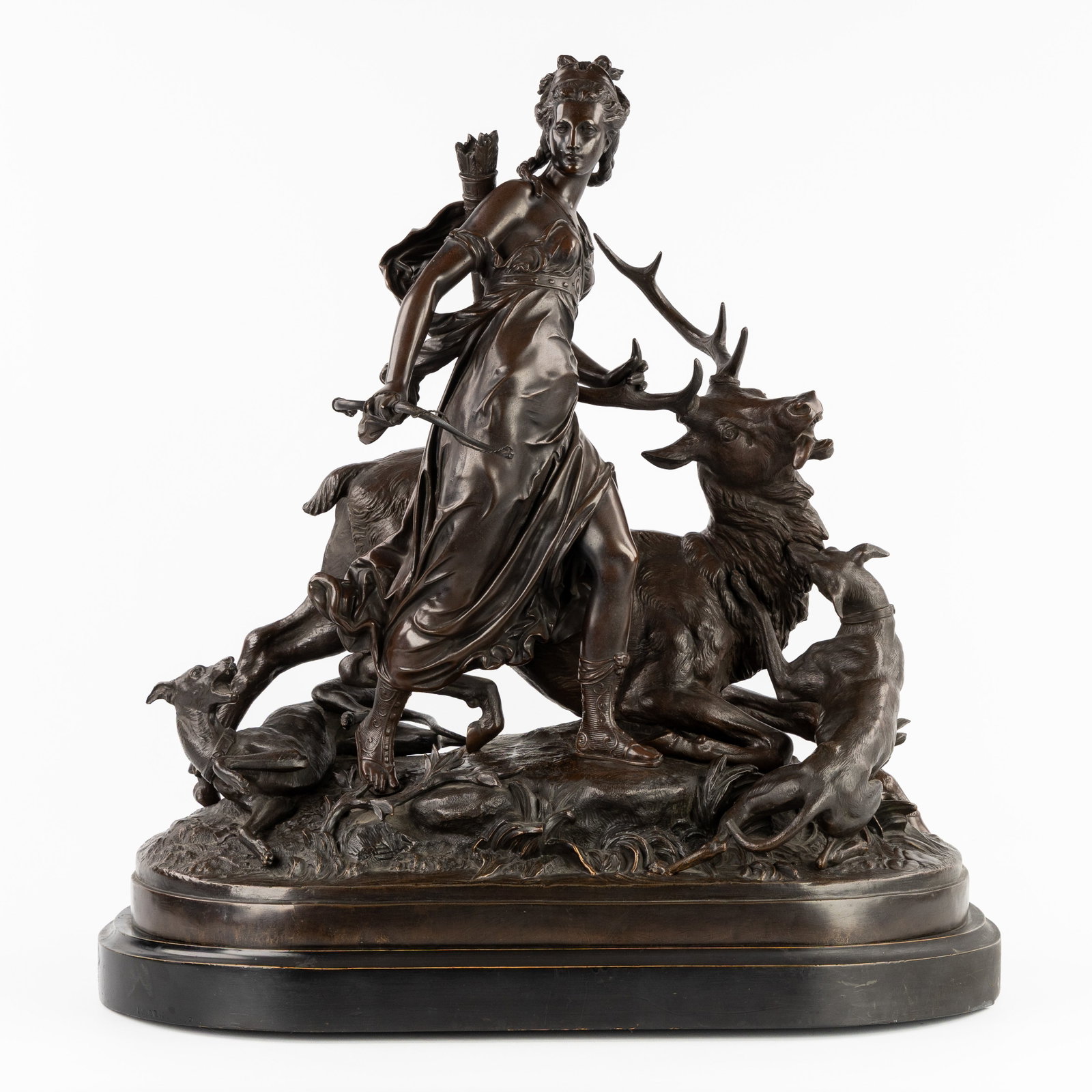An impressive sculpture of Diana, patinated spelter. In the style of Auguste Moreau, Circa 1900.: An impressive sculpture of Diana, patinated spelter. In the style of Auguste Moreau, Circa 1900. Patinated spelter.Depiction of Diana, the Roman goddess of the hunt.Accompanied by a red deer and gre