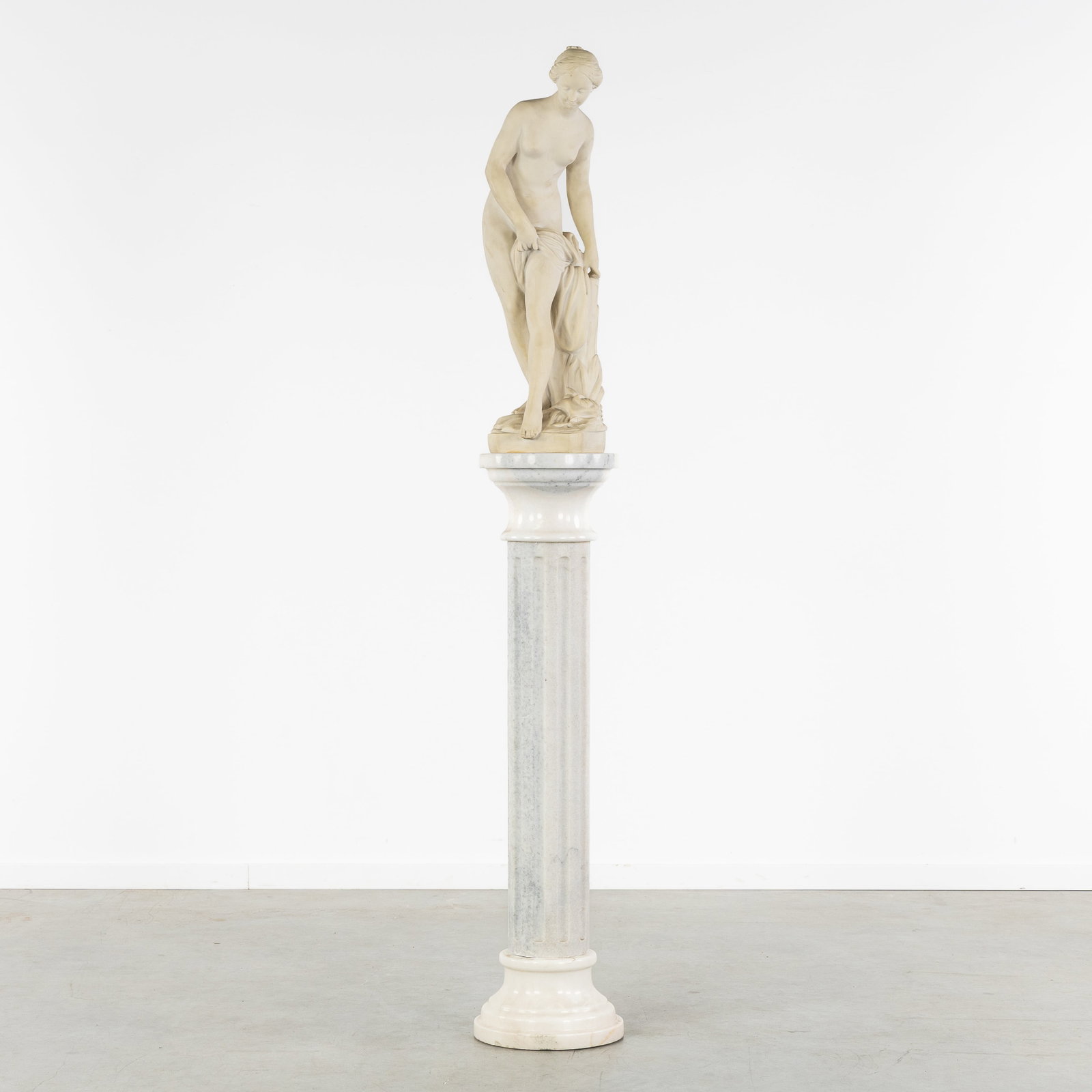 After Etienne Falconet (1716-1791) 'Bathing Venus', a cast marble sculpture on a marble console.: After Etienne Falconet (1716-1791) 'Bathing Venus', a cast marble sculpture on a marble console. Cast marble and marble.Representation of the 'Bathing Venus', after Etienne Maurice Falconet (1716-1791