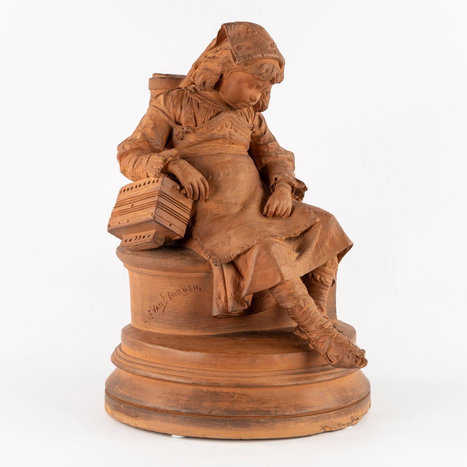 Alphonse I Van Beurden (1854-1938) 'Girl with Accordion', a terracotta sculpture.: Alphonse I Van Beurden (1854-1938) 'Girl with Accordion', a terracotta sculpture. Terracotta.Signed 'Alf. Van Beurden'. (36 x 55 x 45 cm)
