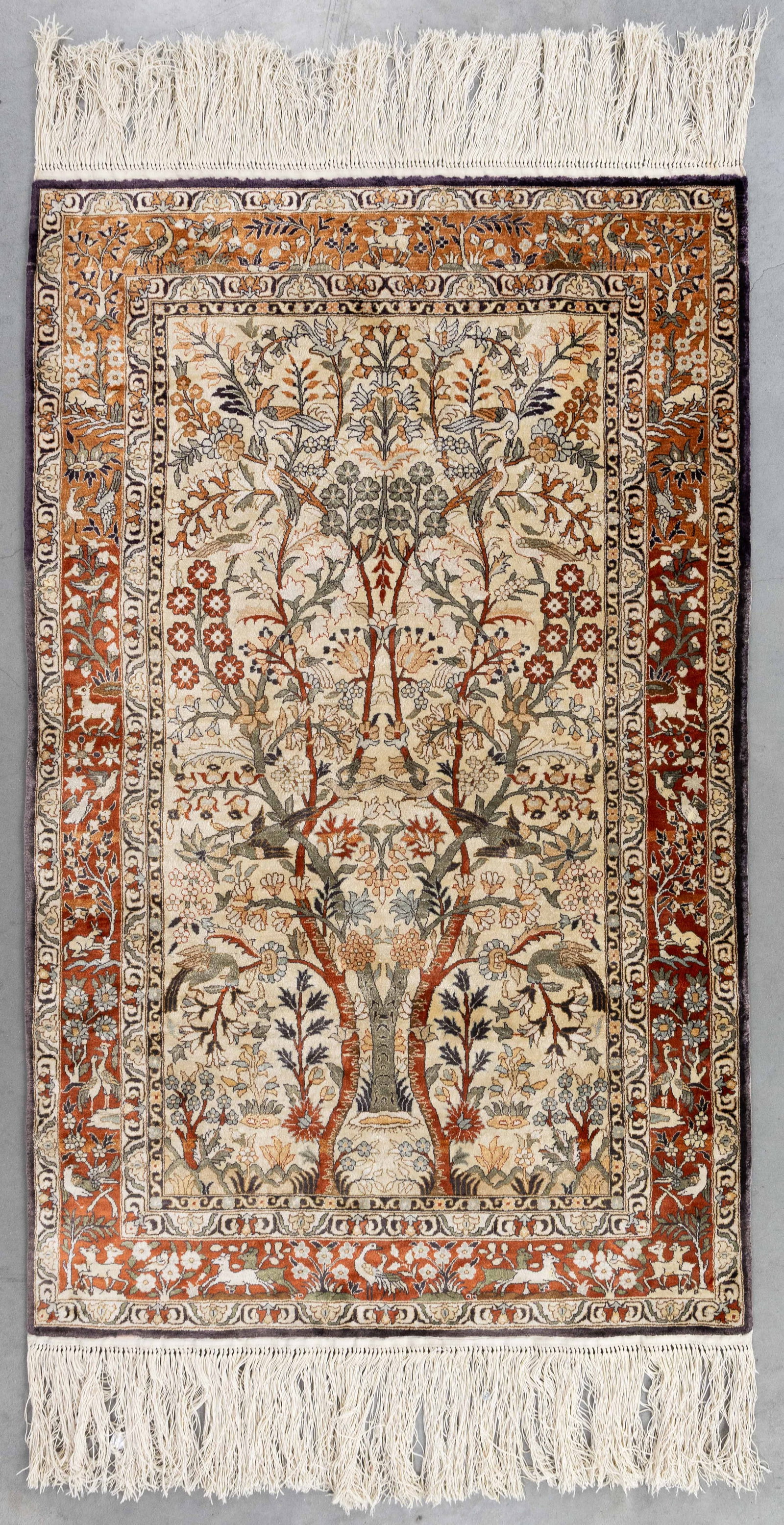 An Oriental hand-made carpet, silk, Isfahan, Iran (124 x 77 cm). (1 of 5)