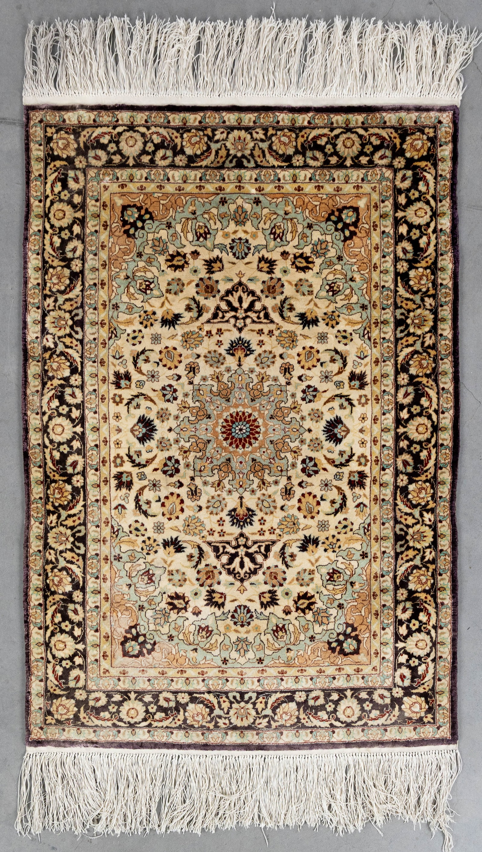 An Oriental hand-made carpet, silk, Mashhad, Iran (93 x 63.5 cm). (1 of 5)
