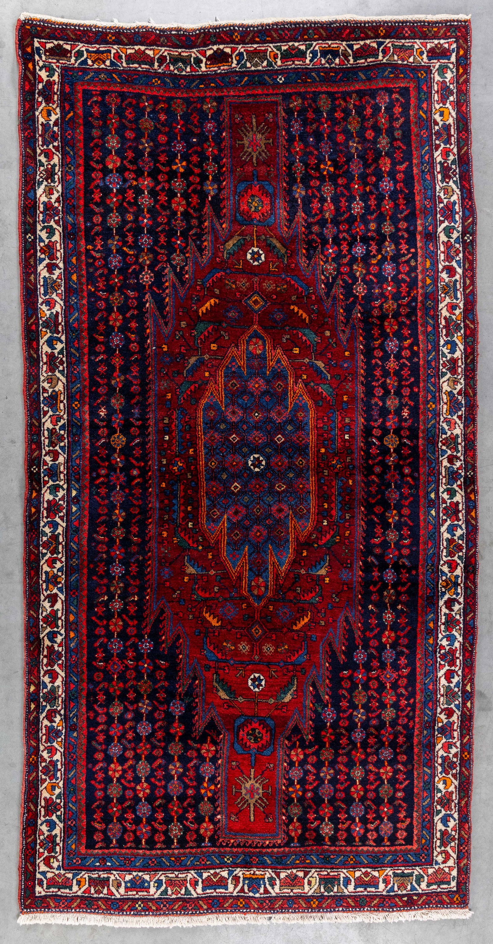 An Oriental hand-made carpet, Sonqor, Iran (272.5 x 144.5 cm). (1 of 6)