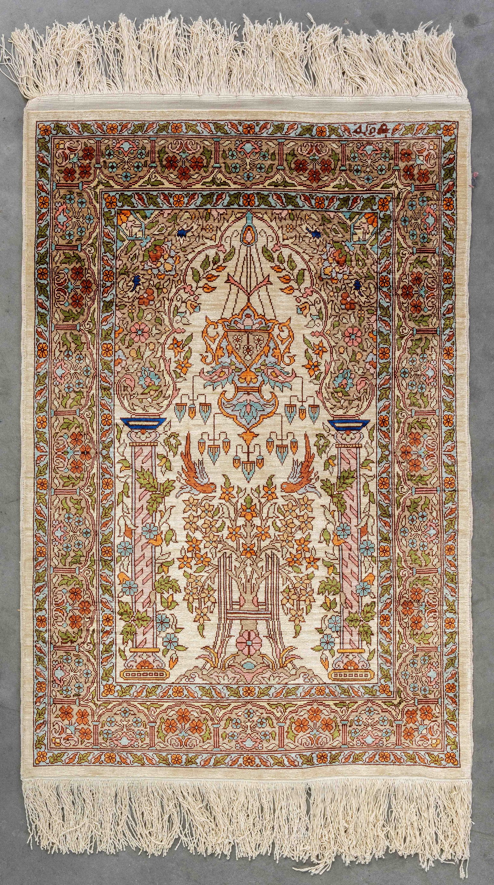 An Oriental hand-made carpet, Hereke, silk, signed (54 x 78 cm). (1 of 8)