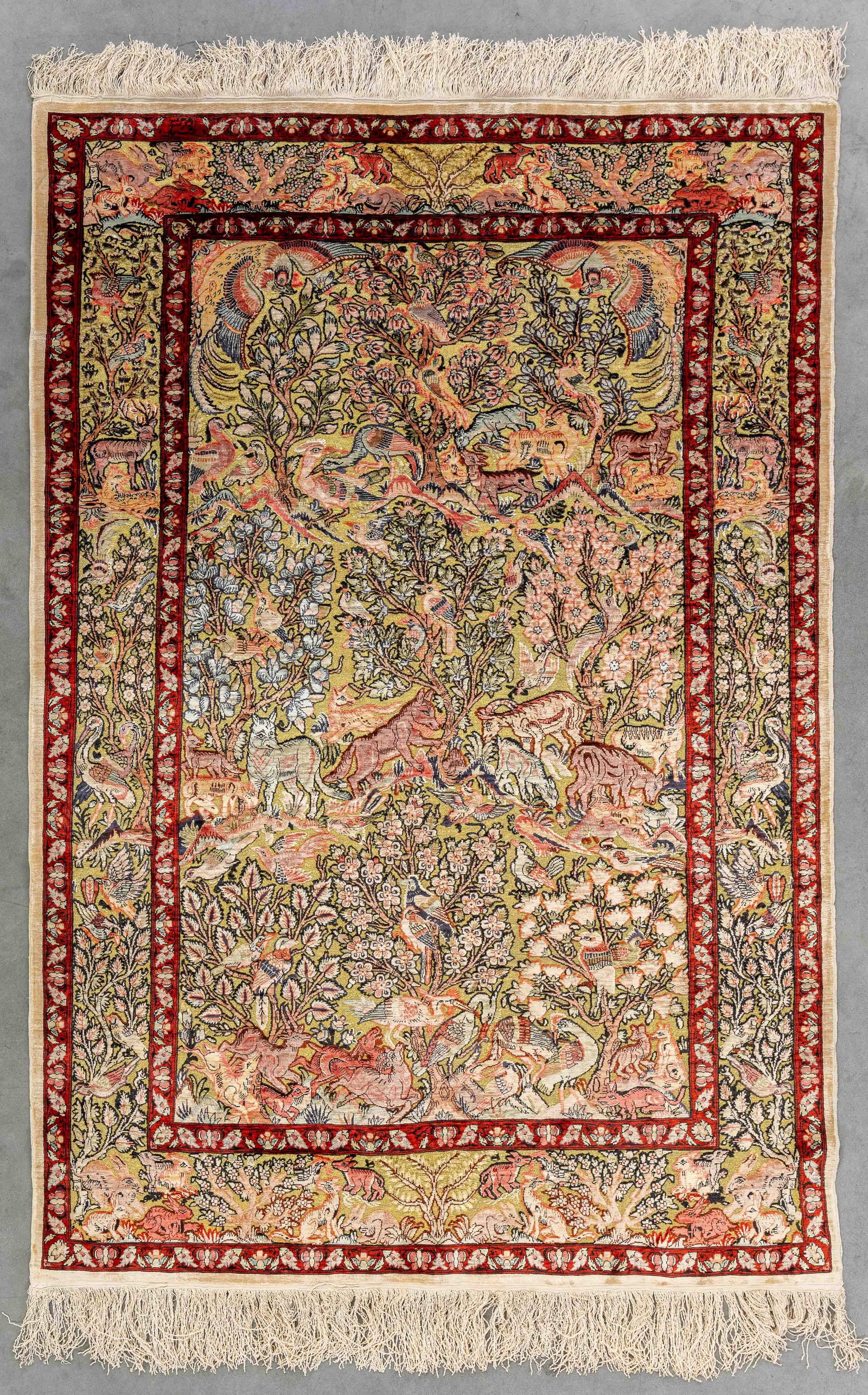An Oriental hand-made figurative carpet, Hereke, silk and gold thread, signed (99 x 147 cm). (1 of 8)