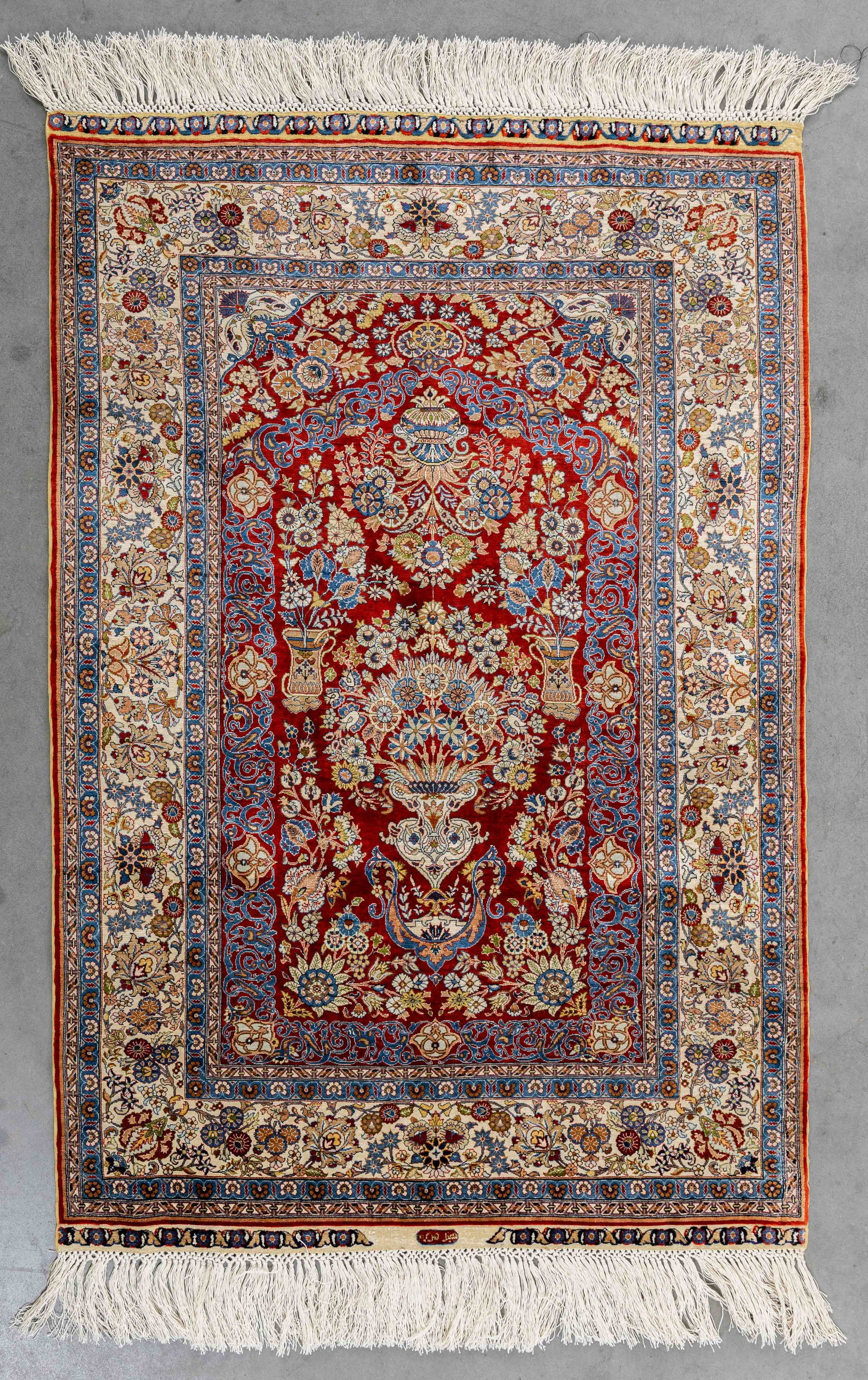 An Oriental hand-made carpet, silk, Hereke, Turkiye, signed (108 x 73 cm).: An Oriental hand-made carpet, silk, Hereke, Turkiye, signed (108 x 73 cm). (73 x 108 x 0 cm)
