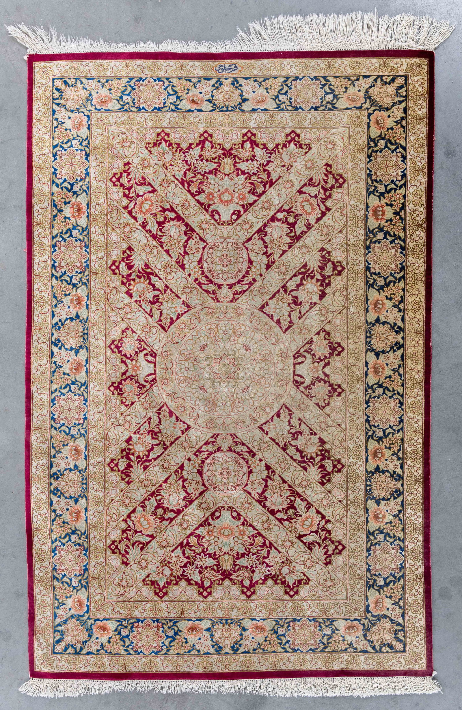 An Oriental hand-made carpet, silk, Ghoum, Iran, signed (120 x 78.5 cm).: An Oriental hand-made carpet, silk, Ghoum, Iran, signed (120 x 78.5 cm). (78.5 x 120 x 0 cm)