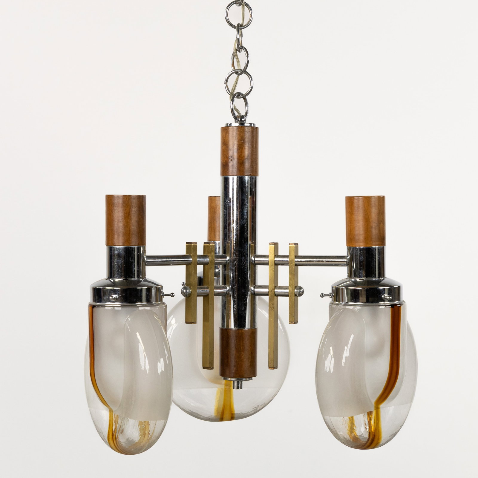 A Murano-style chandelier, chrome-plated metal and glass, circa 1970.: A Murano-style chandelier, chrome-plated metal and glass, circa 1970. Chrome-plated metal, wood, and glass.Three light points. Height including chain: 132 cm. (42 x 47 x 0 cm)