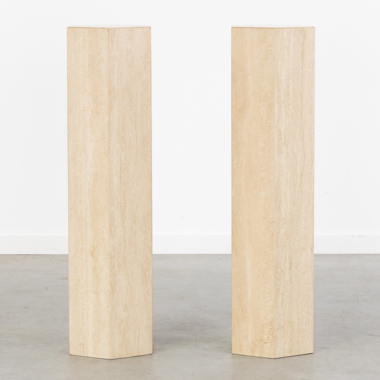 A Pair of decorative hexagonal Consoles or Pedestals, travertine, circa 1980-1990.: A Pair of decorative hexagonal Consoles or Pedestals, travertine, circa 1980-1990. (26 x 90 x 23 cm)