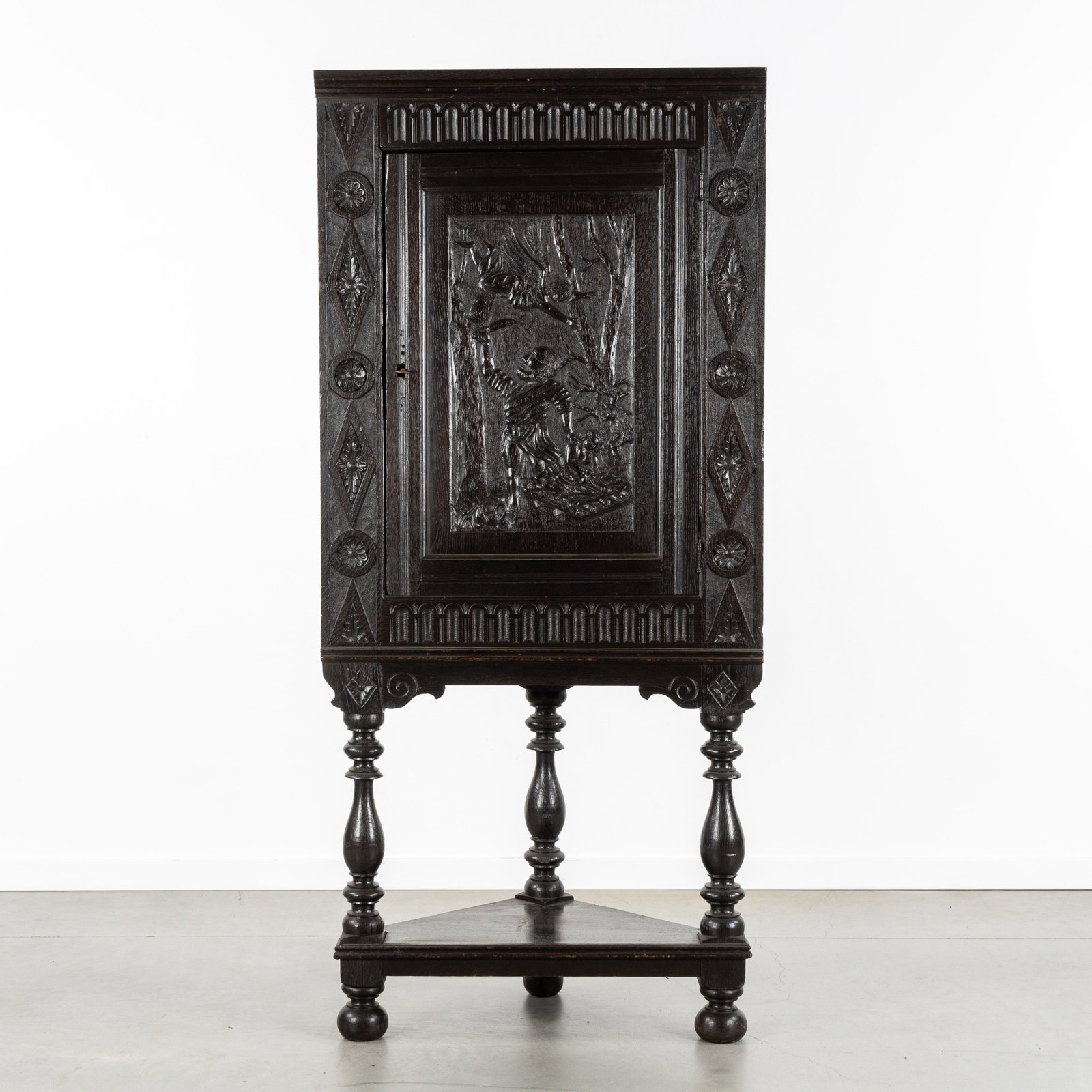 A Bahut Corner cabinet with a sculptured bas-relief 'The Sacrifice of Abraham', Renaissance style,: A Bahut Corner cabinet with a sculptured bas-relief 'The Sacrifice of Abraham', Renaissance style, 18th century. Sculptured wood.Bahut, single-door corner cabinet.Door panel with a sculptured bas-re
