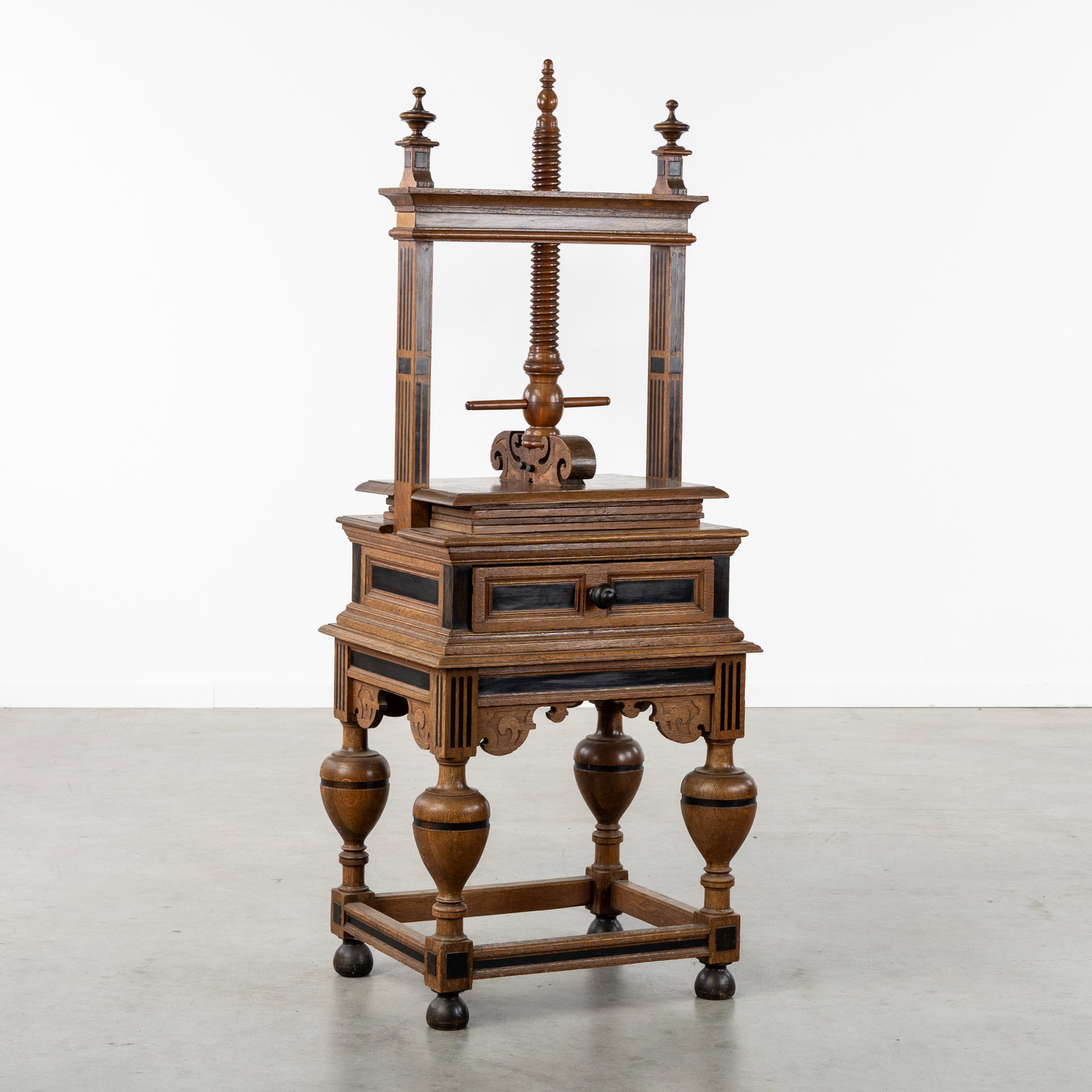 A Zeeland or Dutch linen press, oak with ebony inlay, Renaissance, 17th C.: A Zeeland or Dutch linen press, oak with ebony inlay, Renaissance, 17th century. Sculptured oak.Decorated with ebony fluting or inlay and turned finial vases.Linen press, with four press boards.