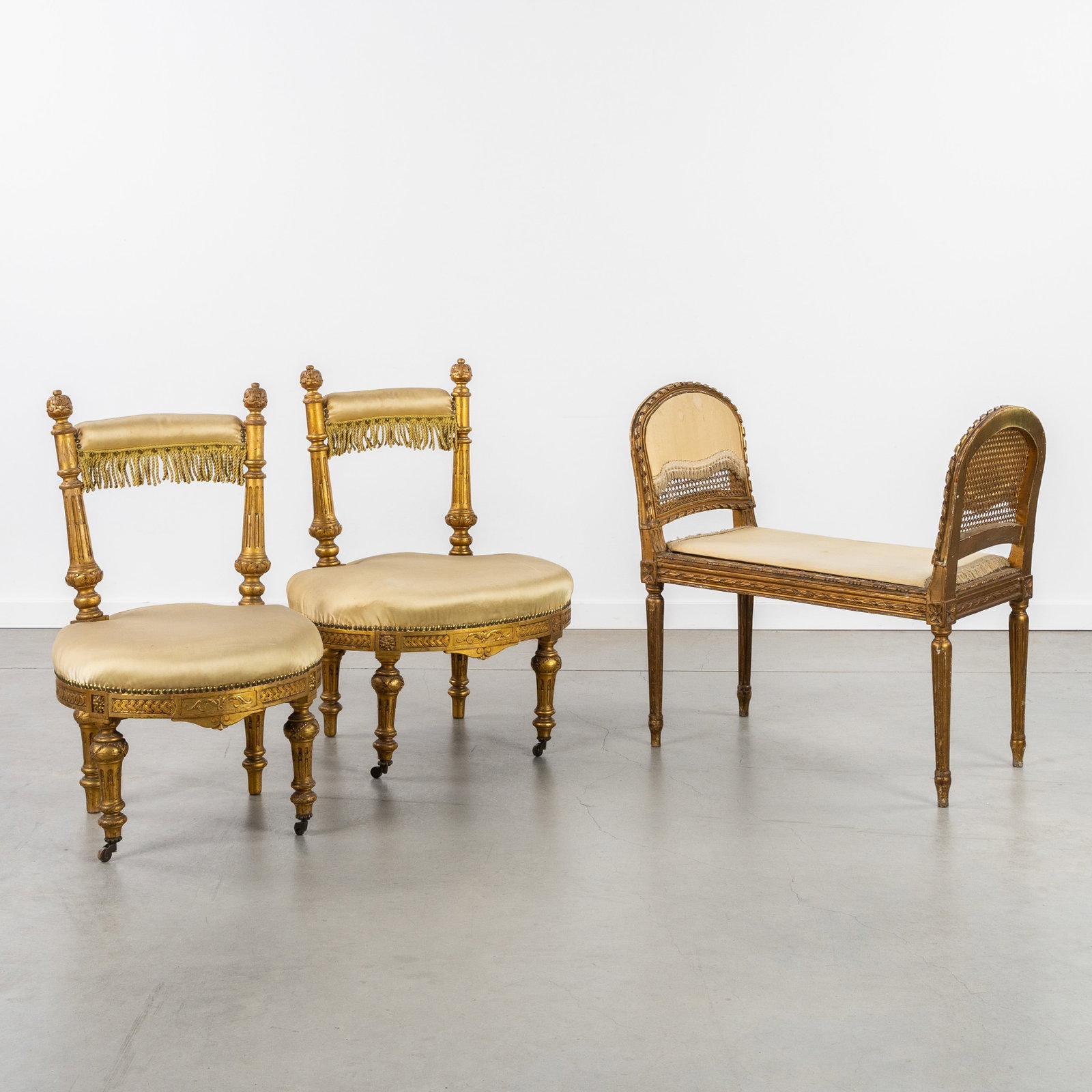 A Pair of 'Fumeuse' chairs and a bench, gilded and sculptured wood, silk, Louis XVI style, France,: A Pair of 'Fumeuse' chairs and a bench, gilded and sculptured wood, silk, Louis XVI style, France, 19th century. Sculptured and gilded wood.Upholstered in fine yellow silk. A pair of s