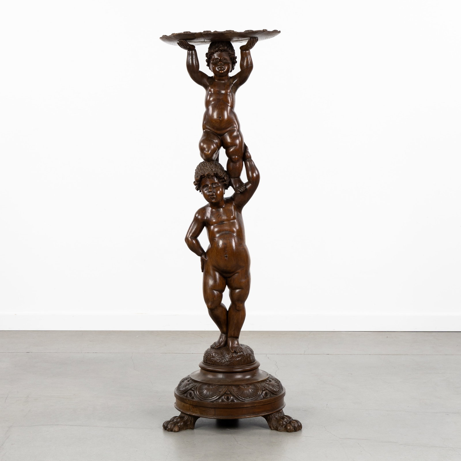 A wood-sculptured console or pedestal with two putti and a plateau in the shape of a scallop shell. (1 of 10)
