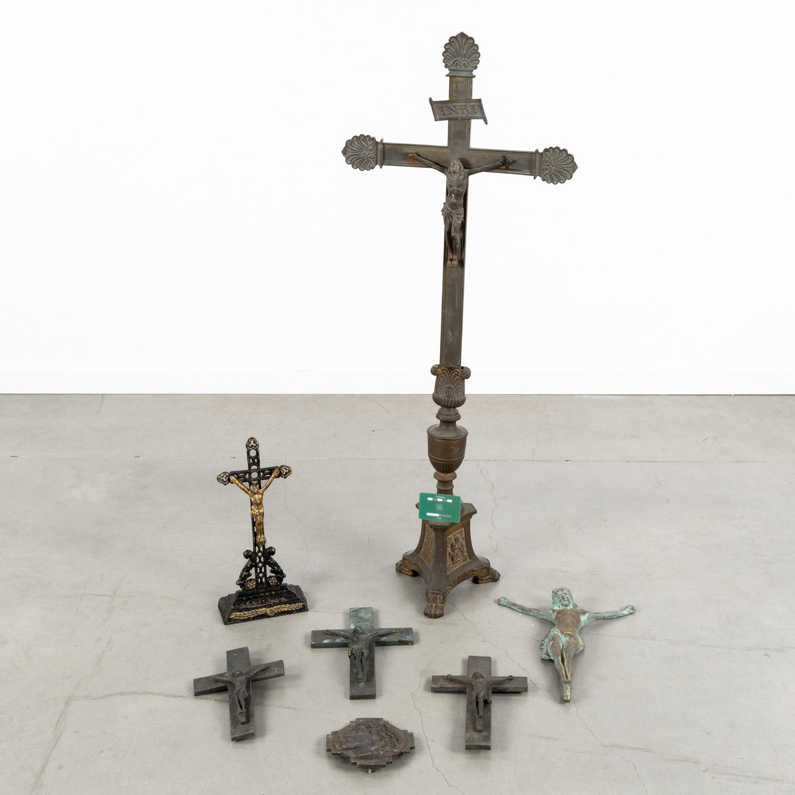 A Large bronze Altar Crucifix with Corpus Christi, added five bronze crucifixes, ornaments, and a: A Large bronze Altar Crucifix with Corpus Christi, added five bronze crucifixes, ornaments, and a cast-iron altar cross, circa 1900. Bronze. Large altar crucifix with Corpus Christi and an INRI banner