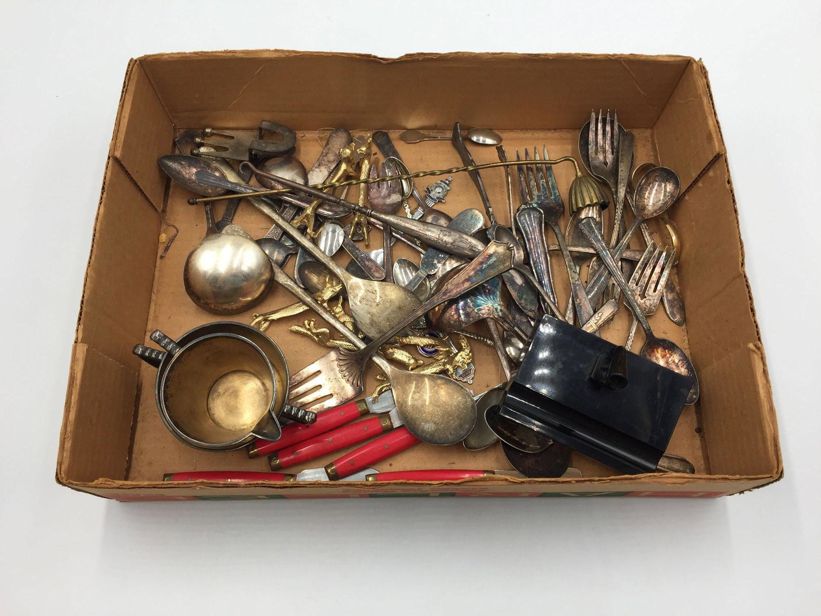 Silver-plated pieces: Box lot of utensils and other items, including The Van Burg SP pieces, souvenir spoons, gold knife rests, candle snuffer, ect. Many are silver plated. Vintage kitchenware and possibly some primitive p
