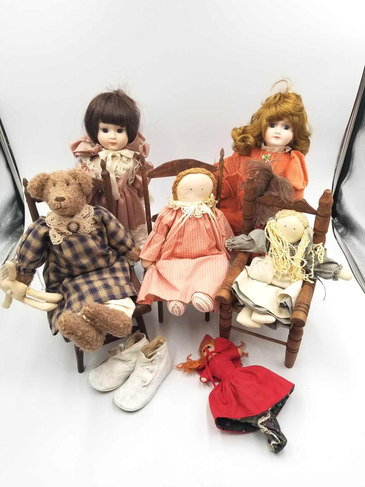 Old Dolls and Doll Chair Lot: Set of vintage dolls and accessories. Comes with three wood-carved chairs, one with a woven seat. Comes with several dolls of various sizes and conditions, including three Amish children's dolls, two 