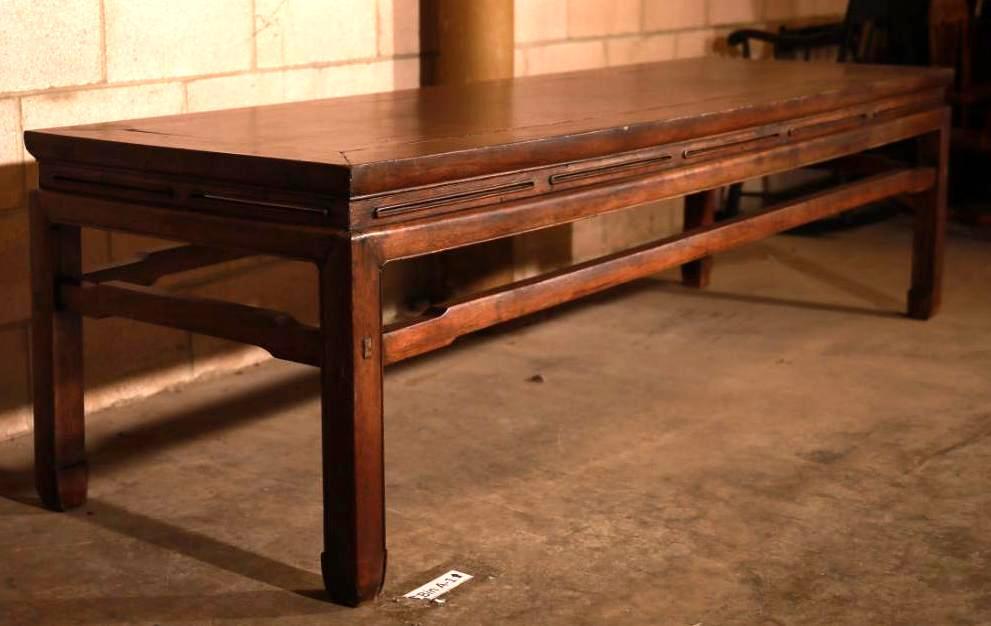 Very Long 20th Century Handmade Wooden Chinese Table: Extra-long vintage Chinese wood table. Has pegged wood joints and a dark finish. Sides showcase a decorative series of slits and squared shaping on the legs and supports. Width: 25 1/2 inches Length: 