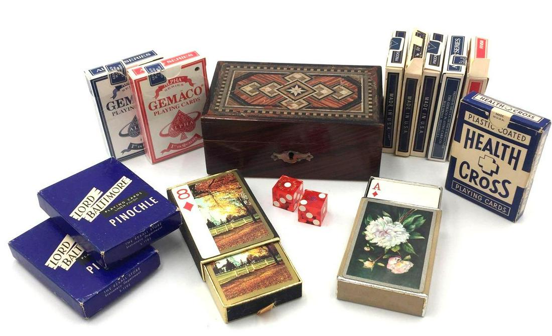 Playing cards, dice, and a wooden bank chest- Box Lot: This lot contains 3 sets of blue Bicycle Pinochle playing cards, 2 sets of blue Gemaco Alpha Series and 1 set of red Gemaco Alpha Series, 1 set pf Hoyle playing cards, 1 set of Health Cross playing ca