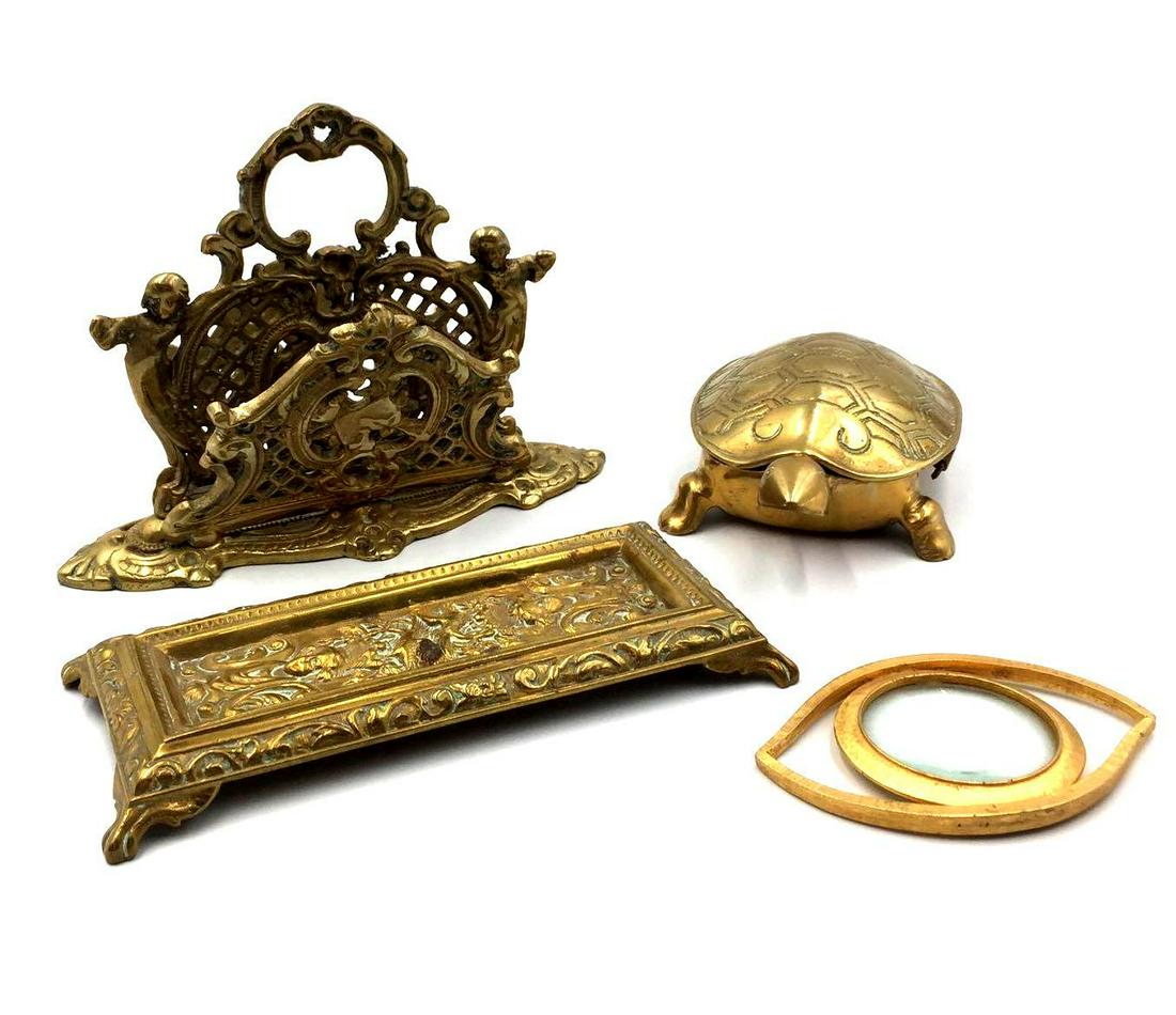 Brass Desk Set: This lot contains one turtle-shaped box, an eye-shaped magnifying glass, a decorative pen holder, and a letter holder.
