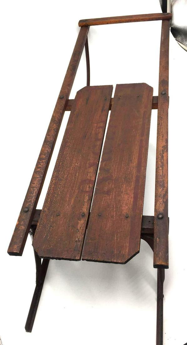 Antique Children's Metal & Wood Sled: This antique sled is constructed of two simple, yet sturdy, wood boards and antique nails sitting on a wood railing frame and metal runners. The metal does have some surface rust which could easily be