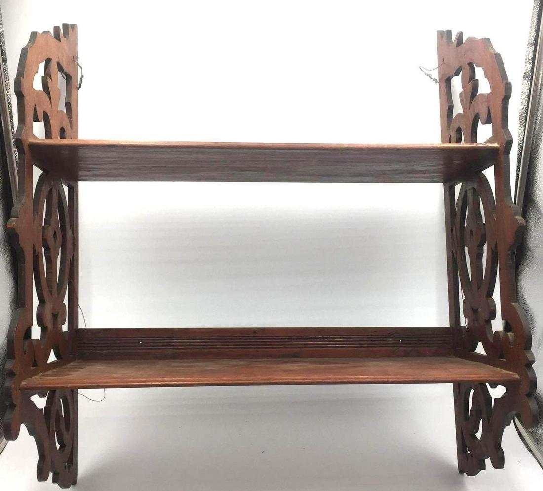 Antique Victorian Knick-Knack Shelf: This two-shelve unit is an antique wooden "knick-knack" shelf. It features hand-carved, decorative side panels and original turn screws. No cracks, splits, or stains. Length: 22 1/4 inches Height: 26 